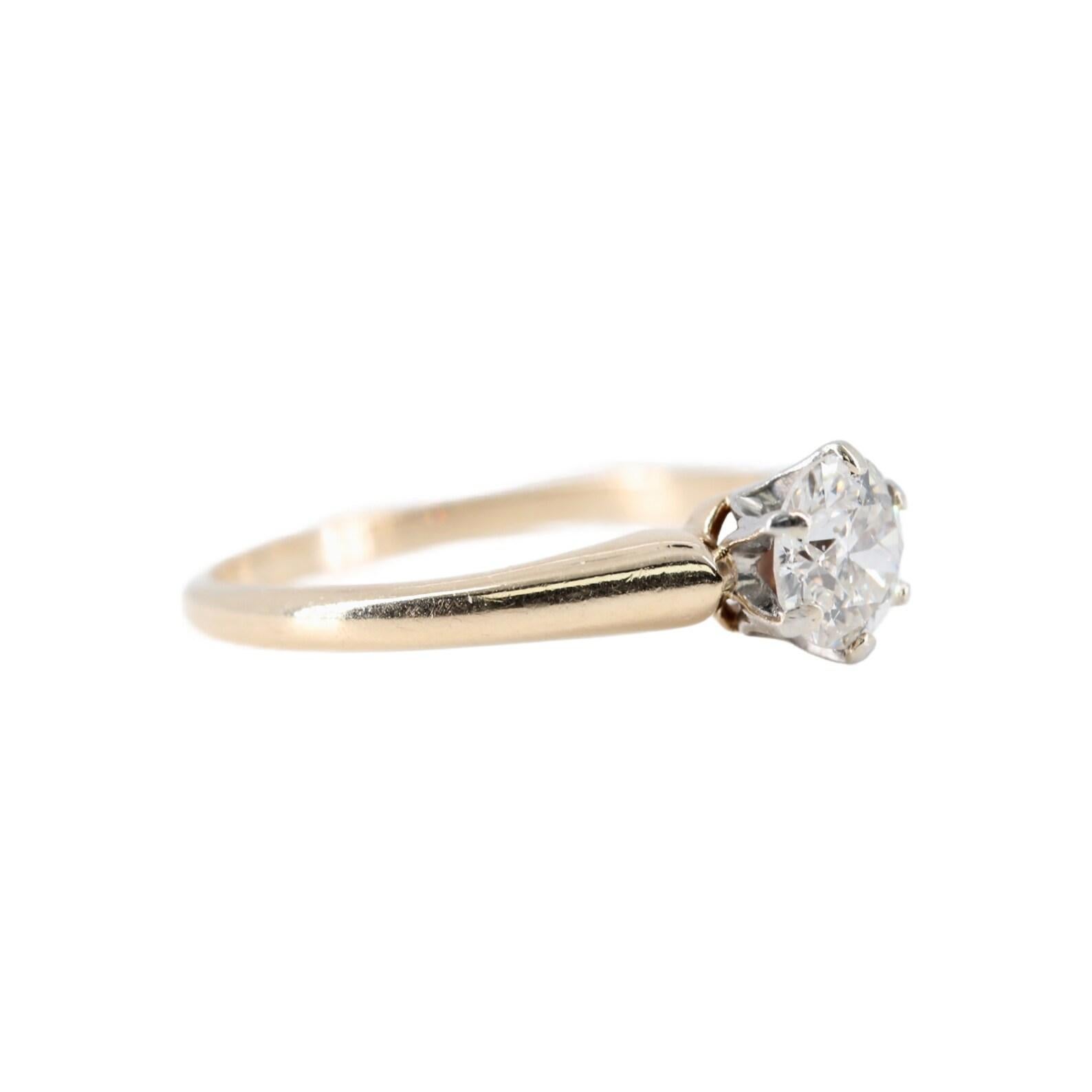 An Edwardian period old European cut diamond solitaire engagement ring. Centered by a 0.60 carat old European cut diamond of H color and SI2 clarity. Set in a platinum claw form head, with a shank of polished 14 karat yellow gold.

Hallmarked as 14