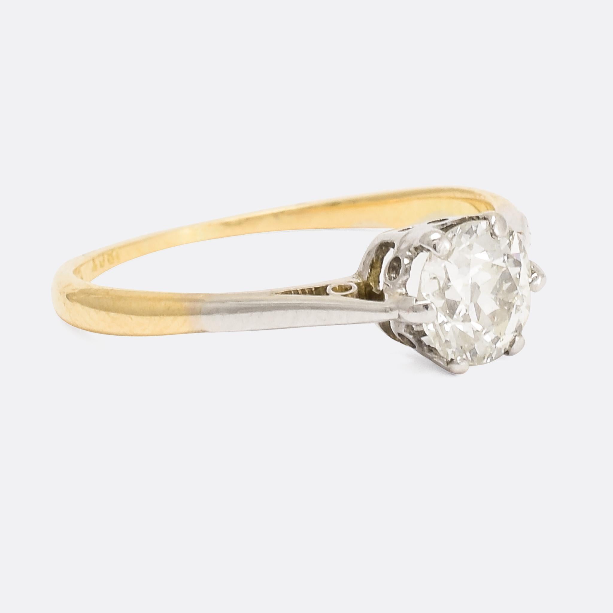 The perfect antique solitaire ring set with a superb 3/4 carat old cushion cut diamond. The ring features a classic six-claw mount in platinum, with an 18k yellow gold band; further platinum accents down the shoulders produce a pleasing two-tone