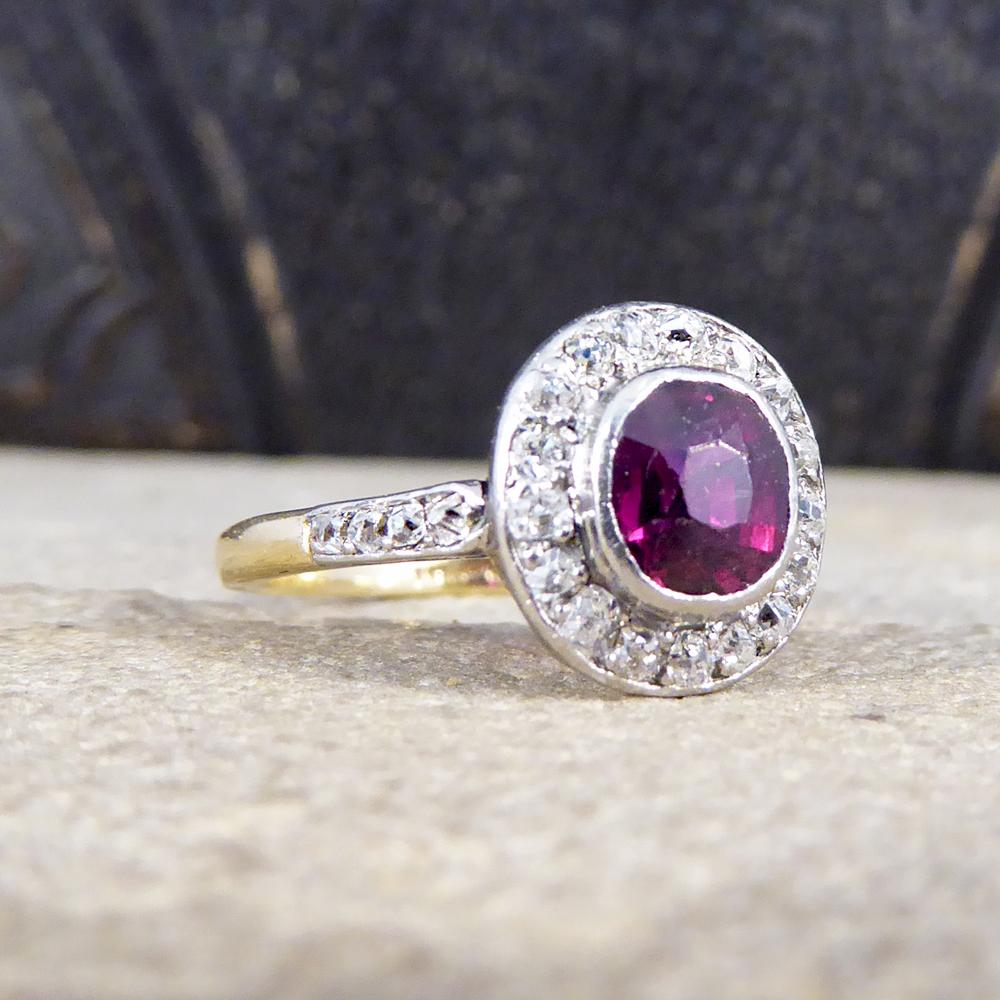 Such a gorgeous ring showing a beautiful red colour in this Ruby weighing 0.85ct setting with a surround of 0.35ct of Diamonds, all set in a rub over collar mount. It contains both 18ct Yellow Gold throughout the band leading up to a Platinum mount