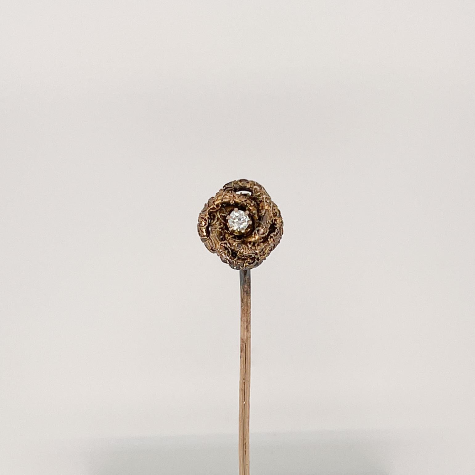 A fine antique Edwardian gold and diamond love knot stickpin.

In 10k gold.

Set with a round white diamond to the center of gold love knot. 

Simply a wonderful stickpin! 

Date:
Early 20th Century

Overall Condition:
It is in overall good,