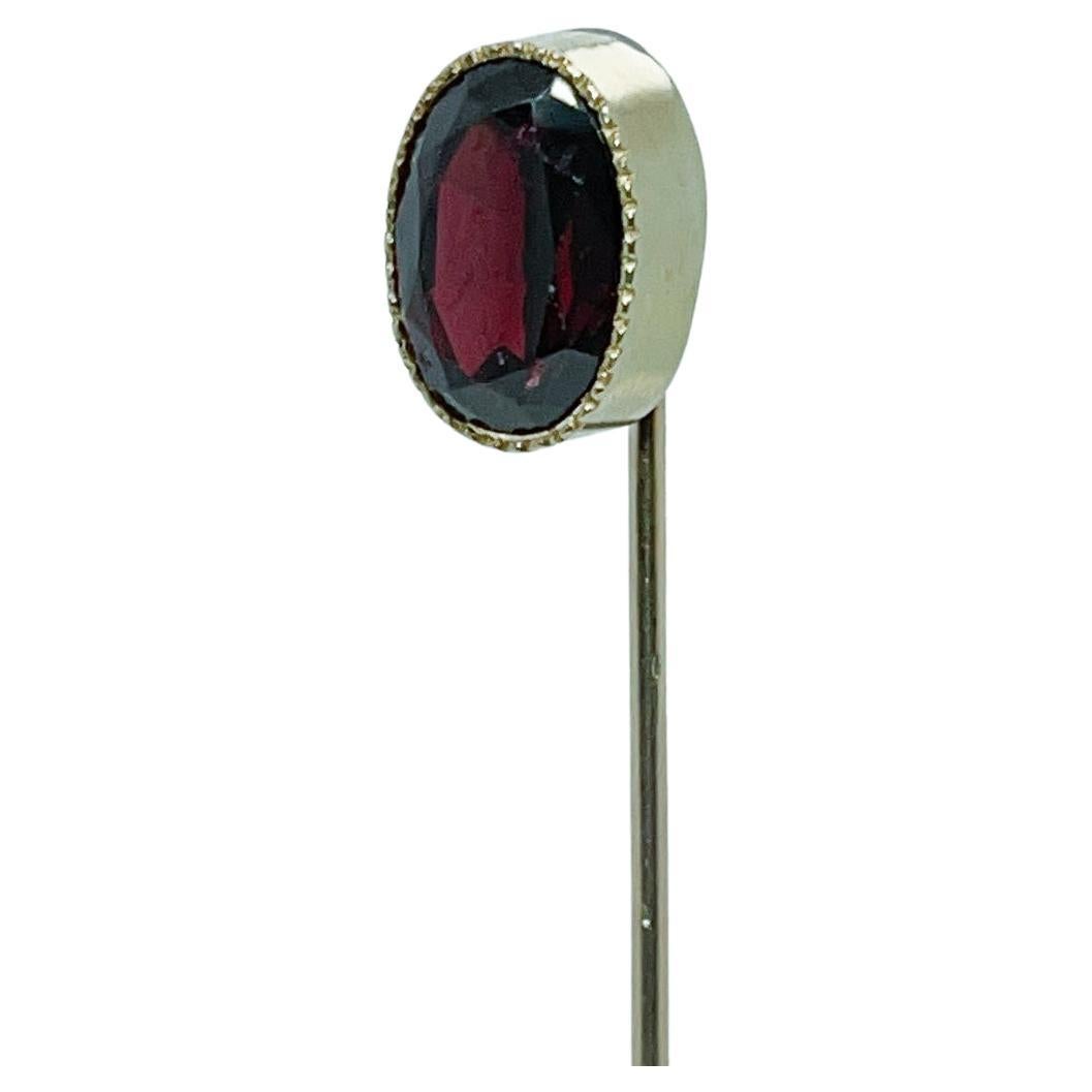 A very fine Edwardian gold and garnet stick pin.

With a faceted oval garnet bezel set in 10k gold.

Simply a great stickpin!

Date:
Early 20th Century

Overall Condition:
It is in overall good, as-pictured, used estate condition with some very fine