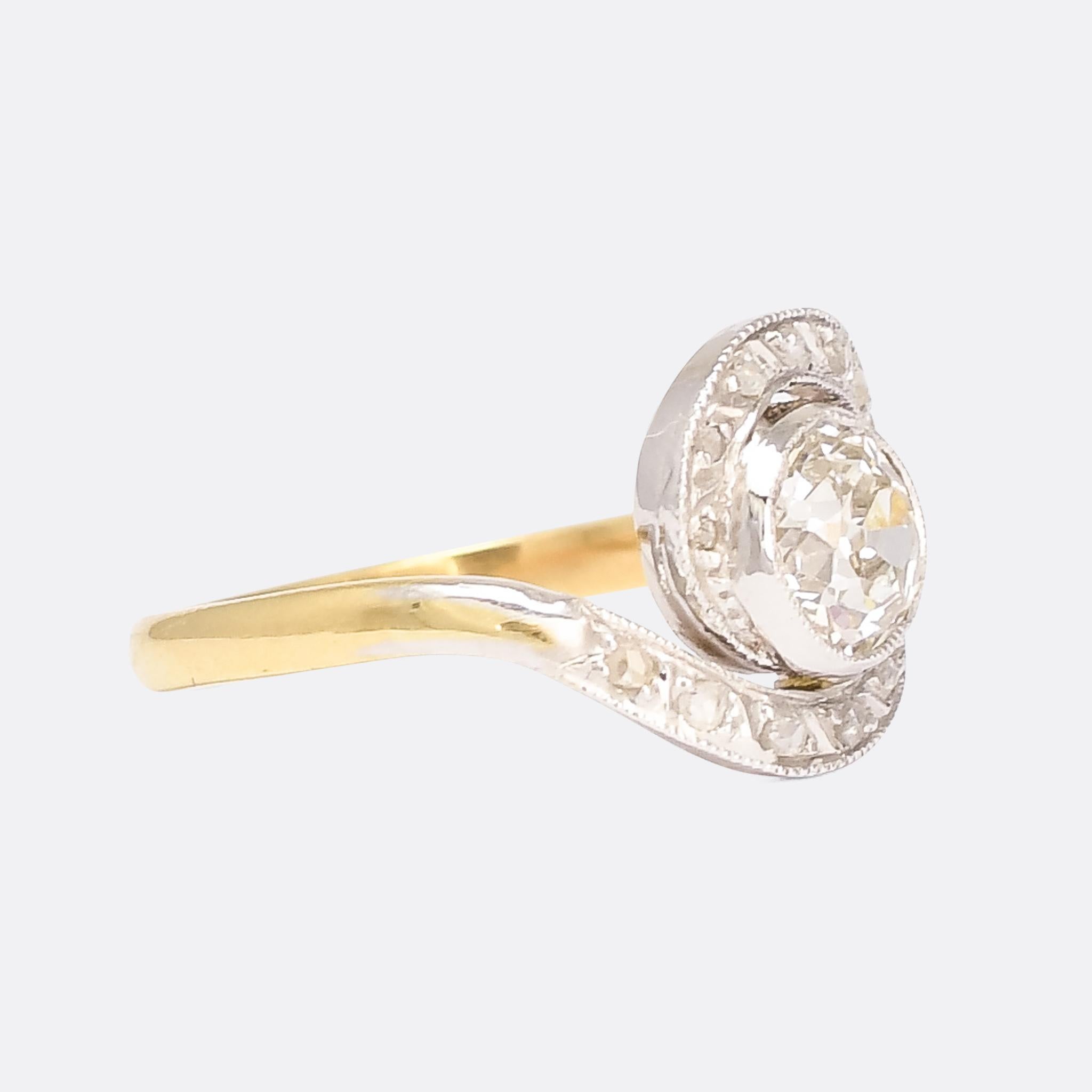 An enchanting antique diamond solitaire ring dating from the Edwardian era, circa 1910. The central stone rests within a swirl of millegrain platinum and rose diamonds, beautifully proportioned and expertly crafted by hand. It was made in France,