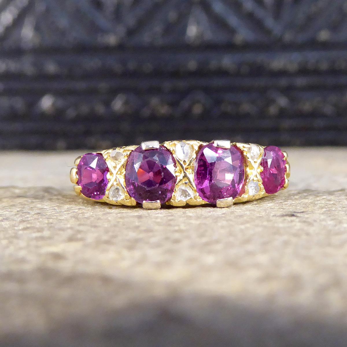 This antique ring was crafted in the Edwardian era. It features a classic swirl gallery and is set in 18ct yellow gold with clear hallmarks on the inner band showing it was crafted in 1907 in Birmingham England. The Rubies are bright and beautiful