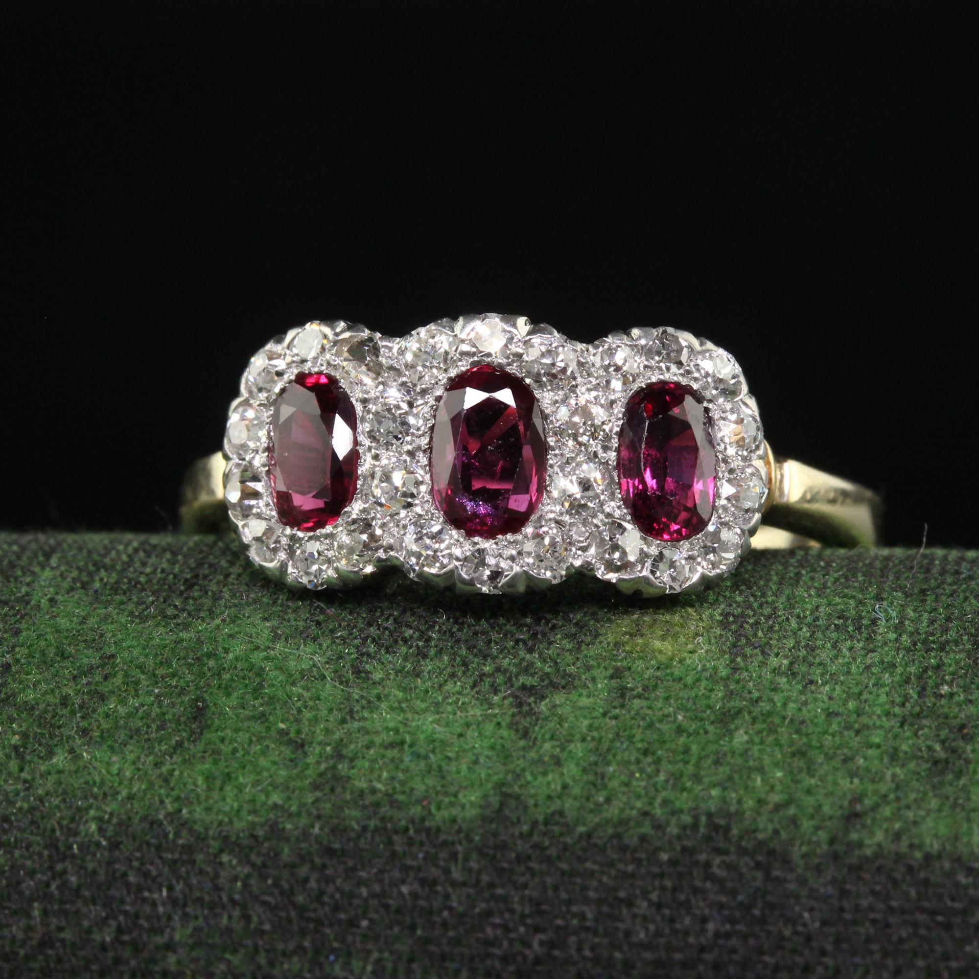 Beautiful Antique Edwardian 12K Gold Platinum Ruby and Old Mine Diamond Three Stone Ring. This incredible Edwardian ruby and diamond ring is crafted in 12k yellow gold and platinum top. The ring features three beautiful old cut oval rubies in the