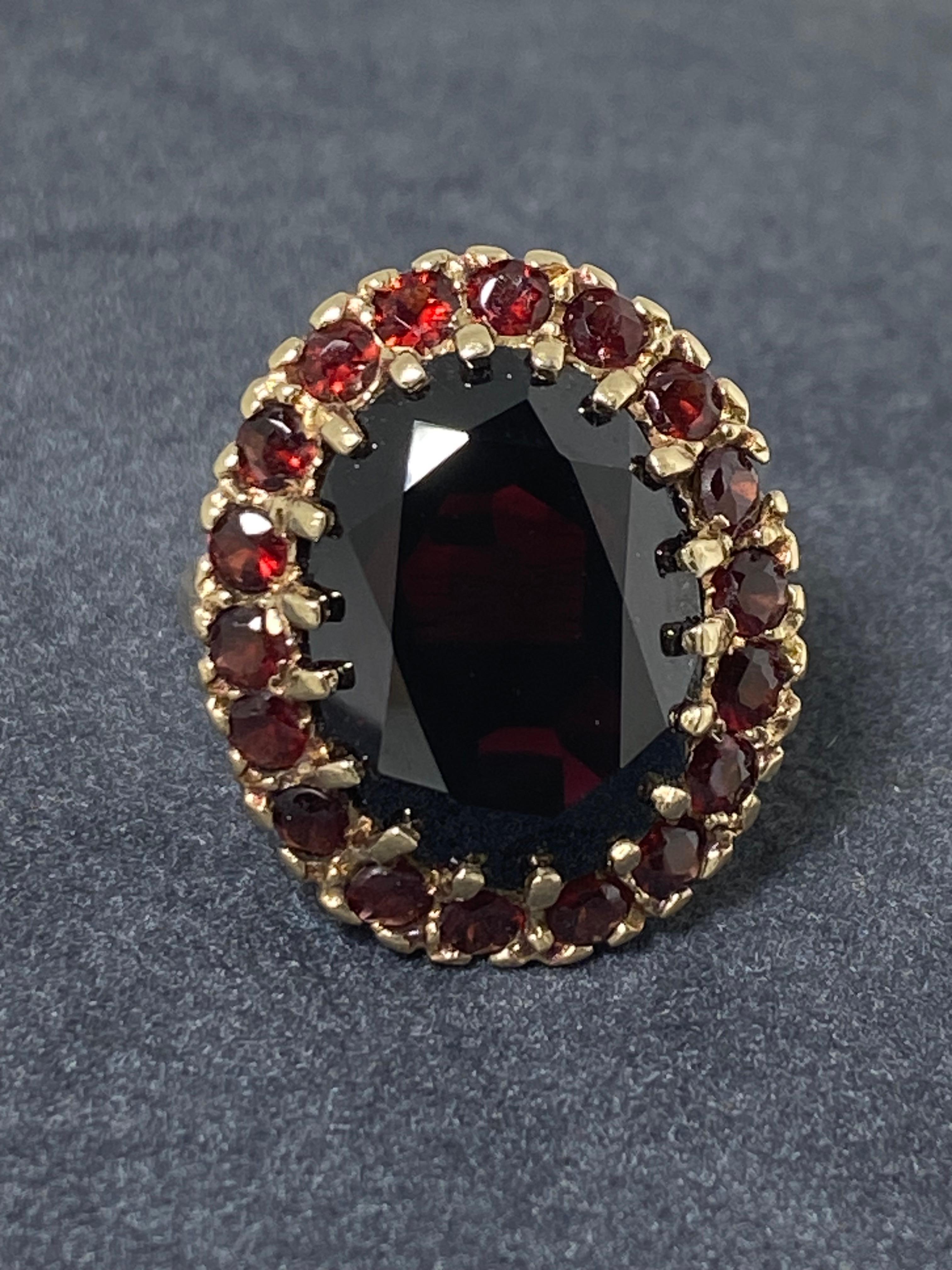 Dating back to an Edwardian era (c 1920's)
this cocktail ring survived 
in remarkable condition 

~~~

Centering a Natural Garnet of top quality, 
of 12.50ct approx. 
(17mm x 13mm)
of intense & deep cherry red colour;

securely claw set 
within a