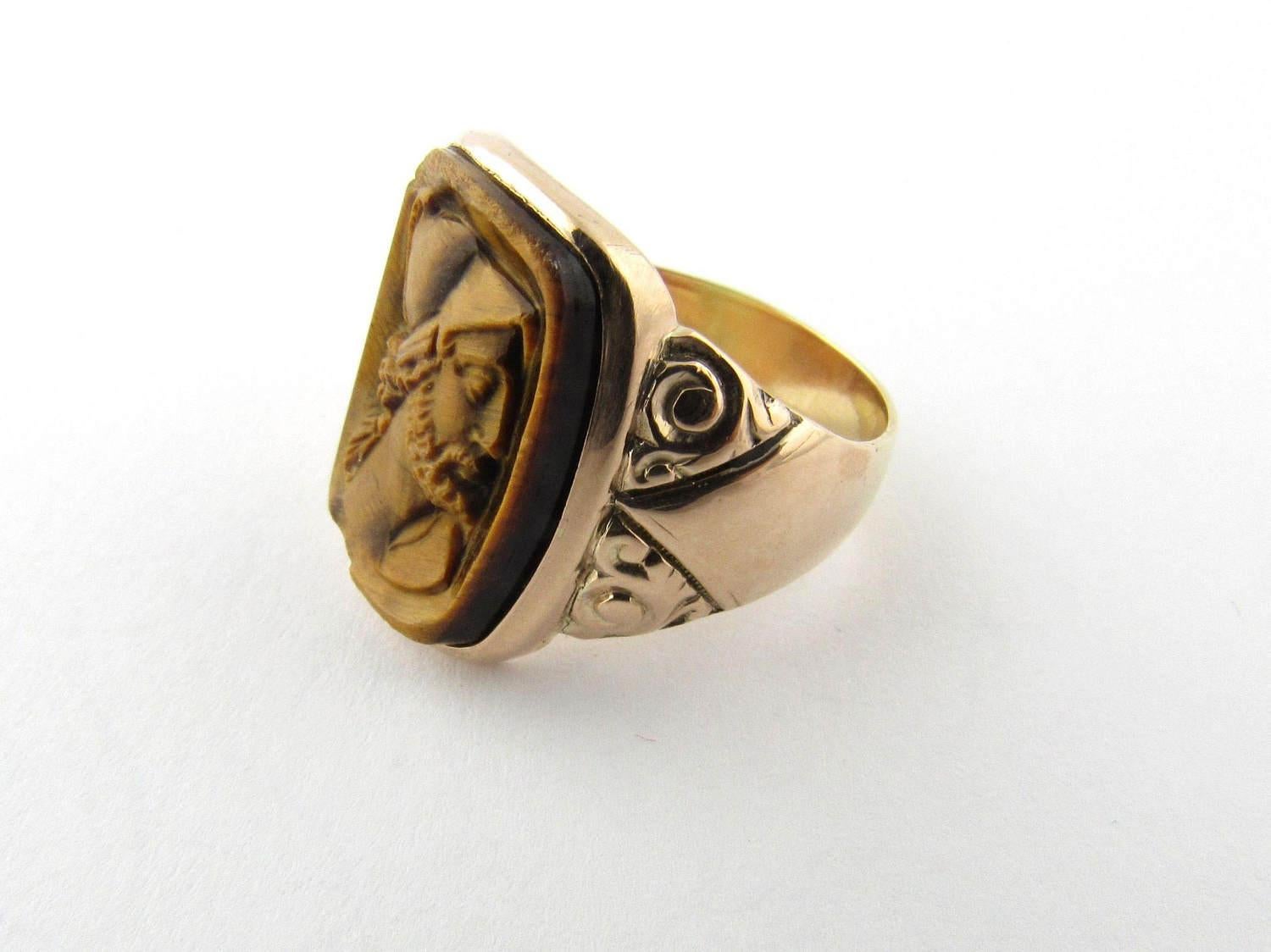 Antique Edwardian 14 Karat Yellow Gold Tiger's Eye Cameo Ring

Mars was the Roman God of war and the most prominent of the military gods in the religion of the Roman army. 

This cameo ring features Mars as a Roman soldier carved in genuine tiger's
