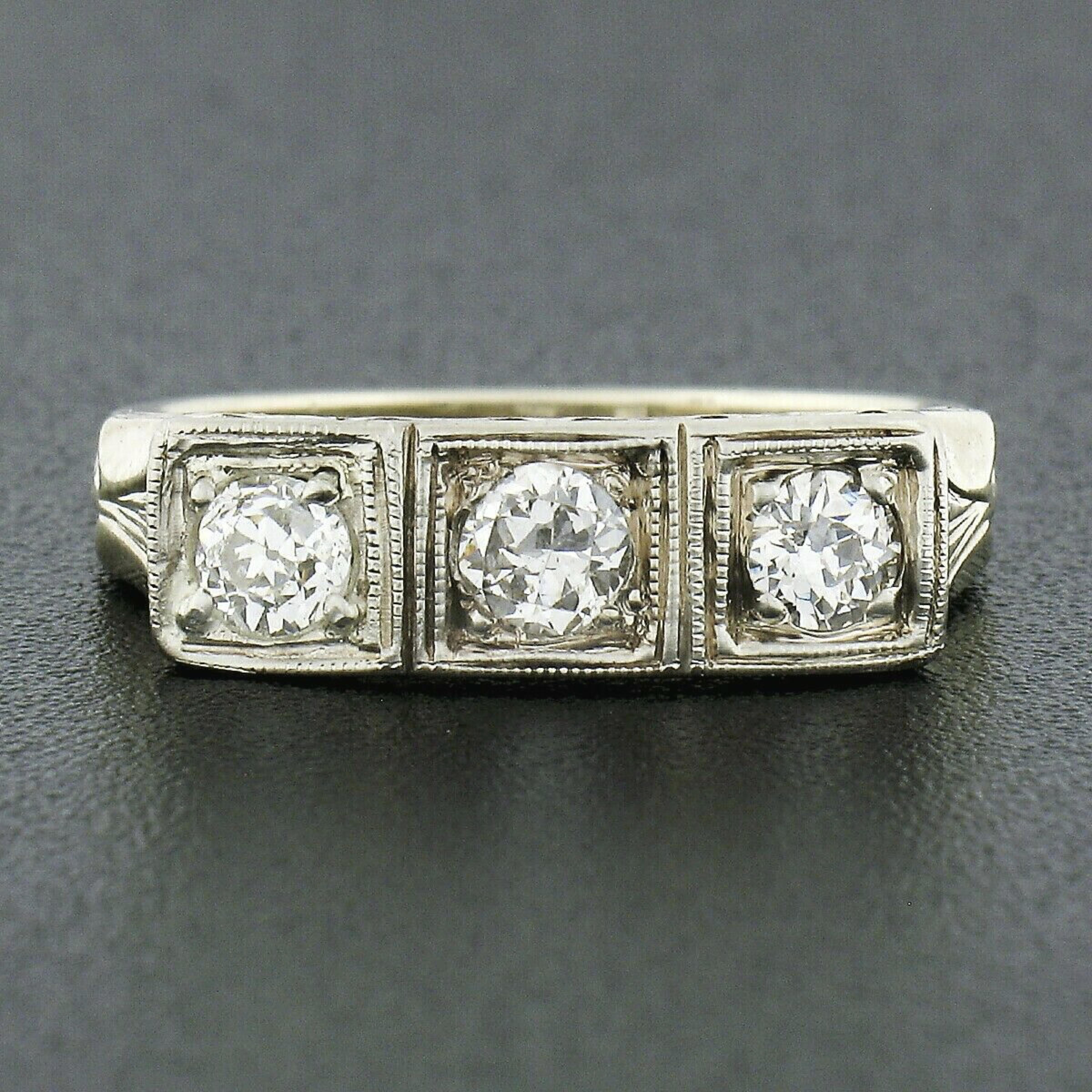 This outstanding antique band ring was crafted during the Edwardian period in solid 14k yellow gold with a white gold top that carries three very fine quality diamonds. These stunning old European cut stones total approximately 0.52 carats in weight