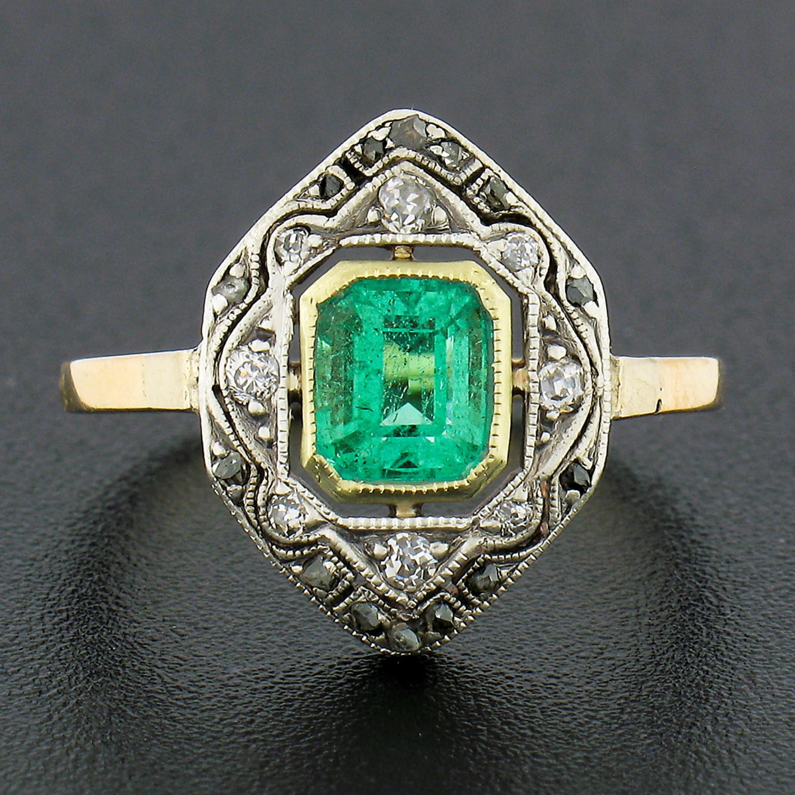 This gorgeous antique platter ring was crafted from solid 14k yellow gold and silver during the Edwardian period. It features a very fine natural emerald neatly bezel set at the open center displaying the most gorgeous, truly vivid, medium green