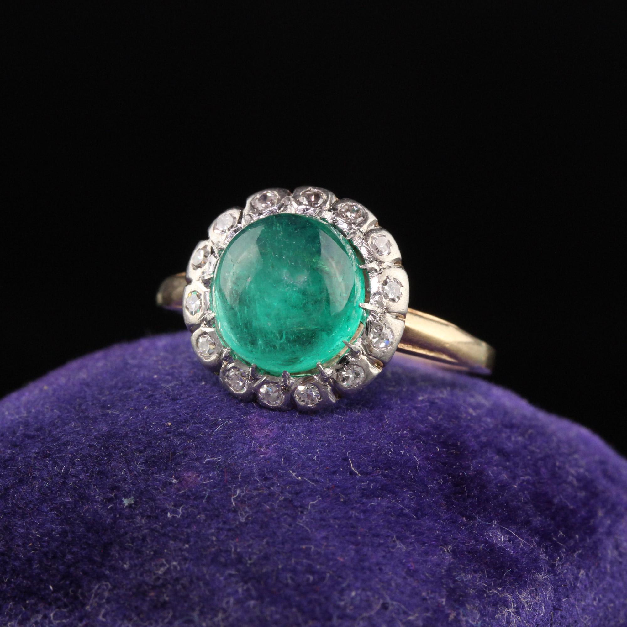 Beautiful Antique Edwardian 14K Yellow Gold Platinum Top Colombian Emerald Engagement Ring. This gorgeous ring is crafted in 14k yellow gold and platinum top. The center holds a beautiful green Colombian cabochon emerald surrounded by old cut