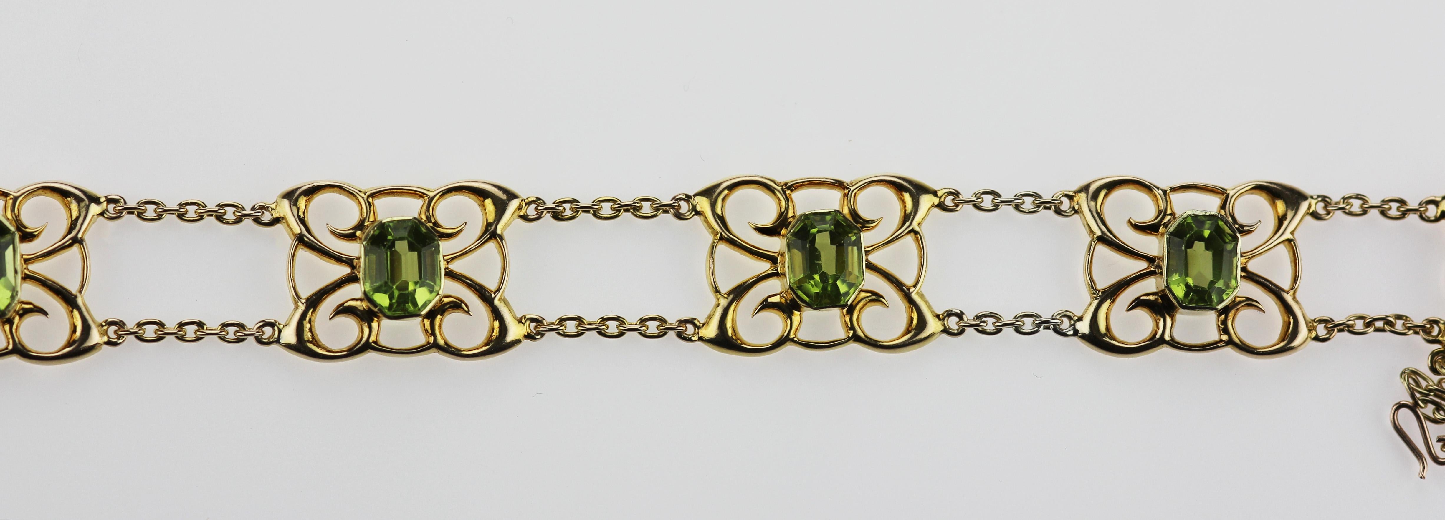 An antique Edwardian 15 ct yellow gold bracelet set with peridots and safety chain attached. Seven peridot in rectangular emerald cut, approximate total weight 7.0 cts. 
Bracelet Length: 19.0 cm
Bracelet Width: 12.5 mm
Gross weight: 16.0 grams