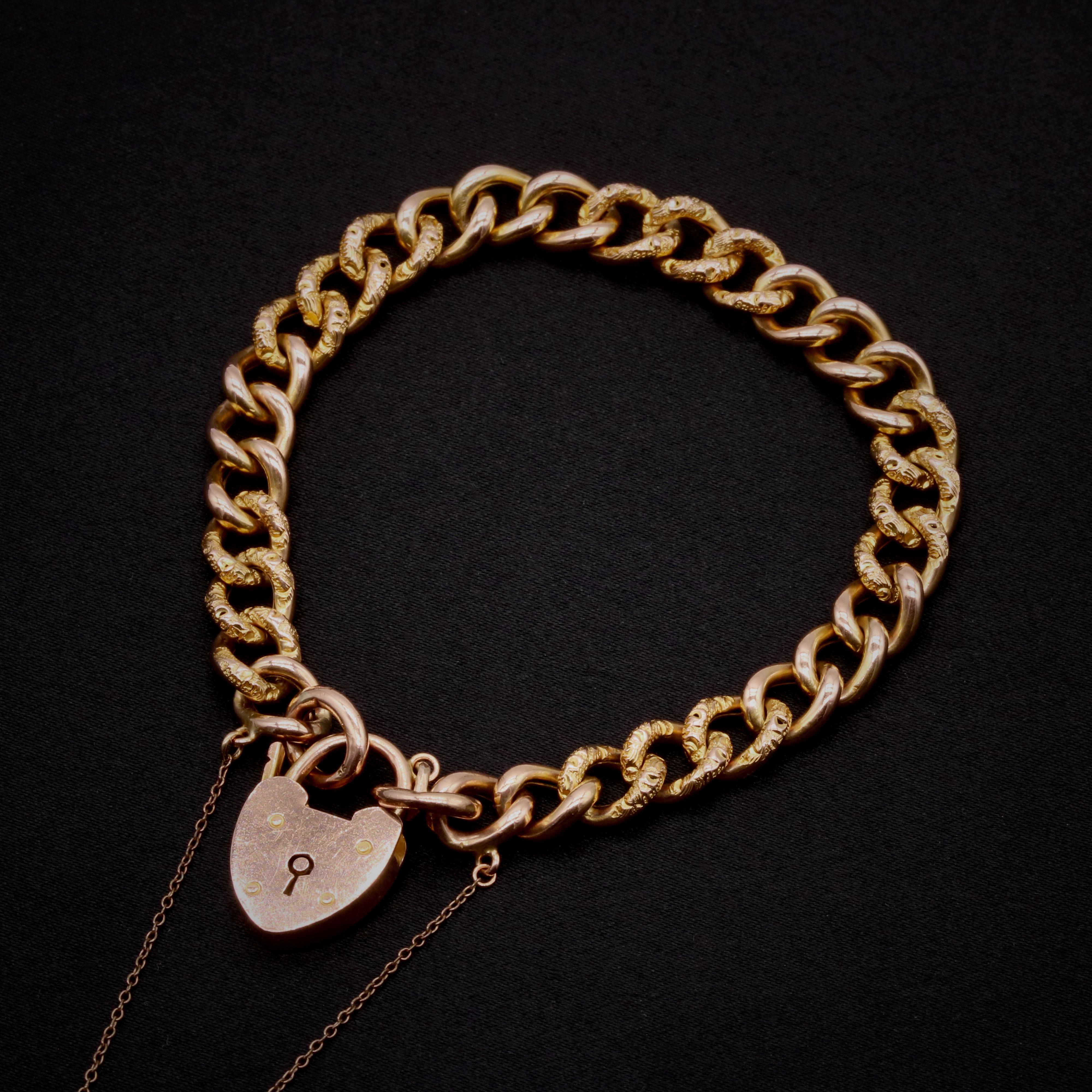 An Edwardian gold bracelet, comprising plain and chased curb links, a padlock clasp, and safety chain, in 9 karat rosy yellow gold.

This beautiful bracelet is made up of hollow curb links, alternating between 3 plain, and 3 textured chased links.
