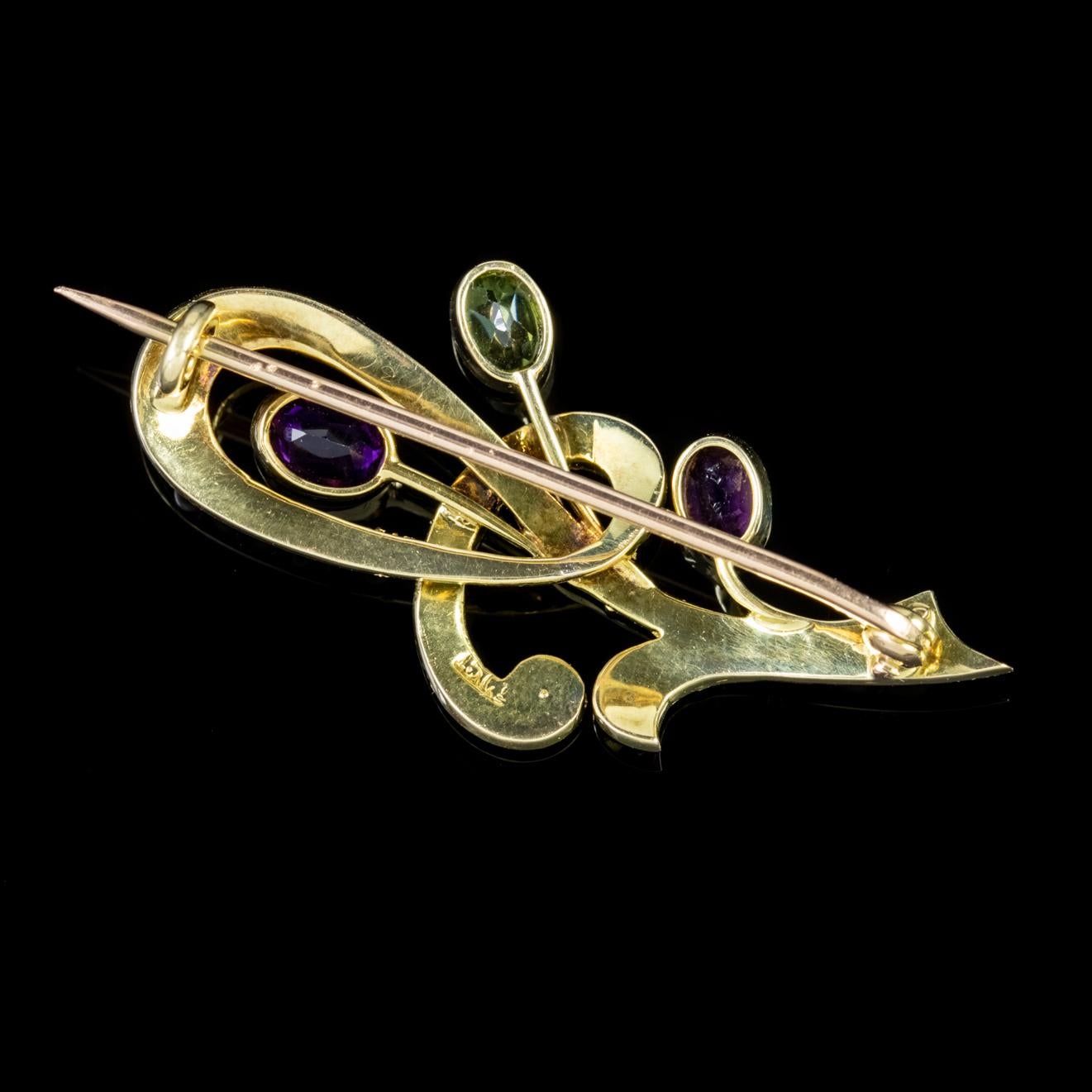 This stunning Edwardian brooch is crafted around two beautiful Amethysts, a single bright Peridot and an array of Pearls.

Fashioned in 15ct Yellow Gold, with 0.08ct Peridots and Amethysts, this brooch is a beautiful example of the jewellery made