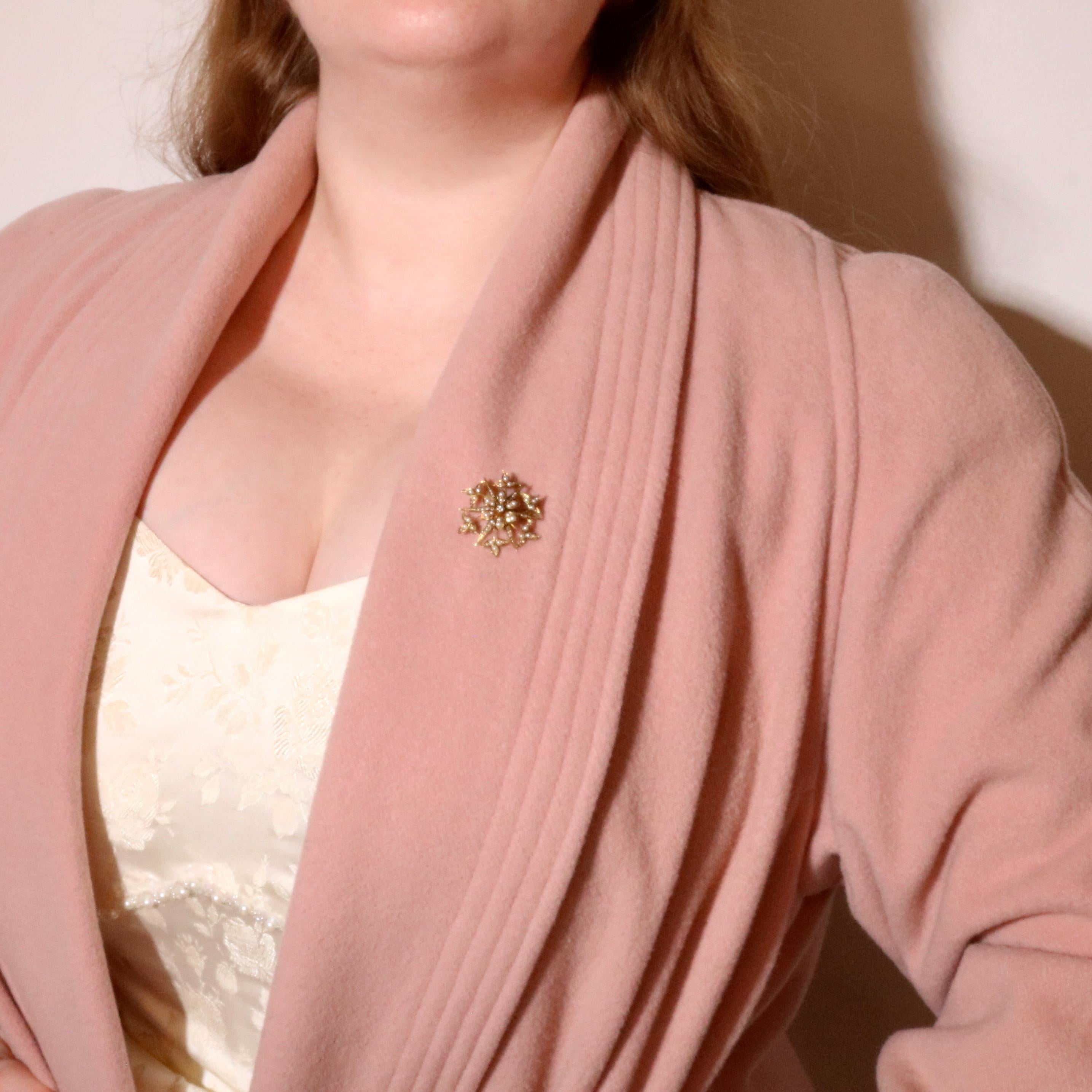 An Edwardian pearl, diamond, and yellow gold brooch and pendant, comprising one old European cut diamond, and seventy-four half seed pearl, set in 15 karat yellow gold, with 15 karat yellow gold pin and fittings. 

This beautiful Edwardian brooch