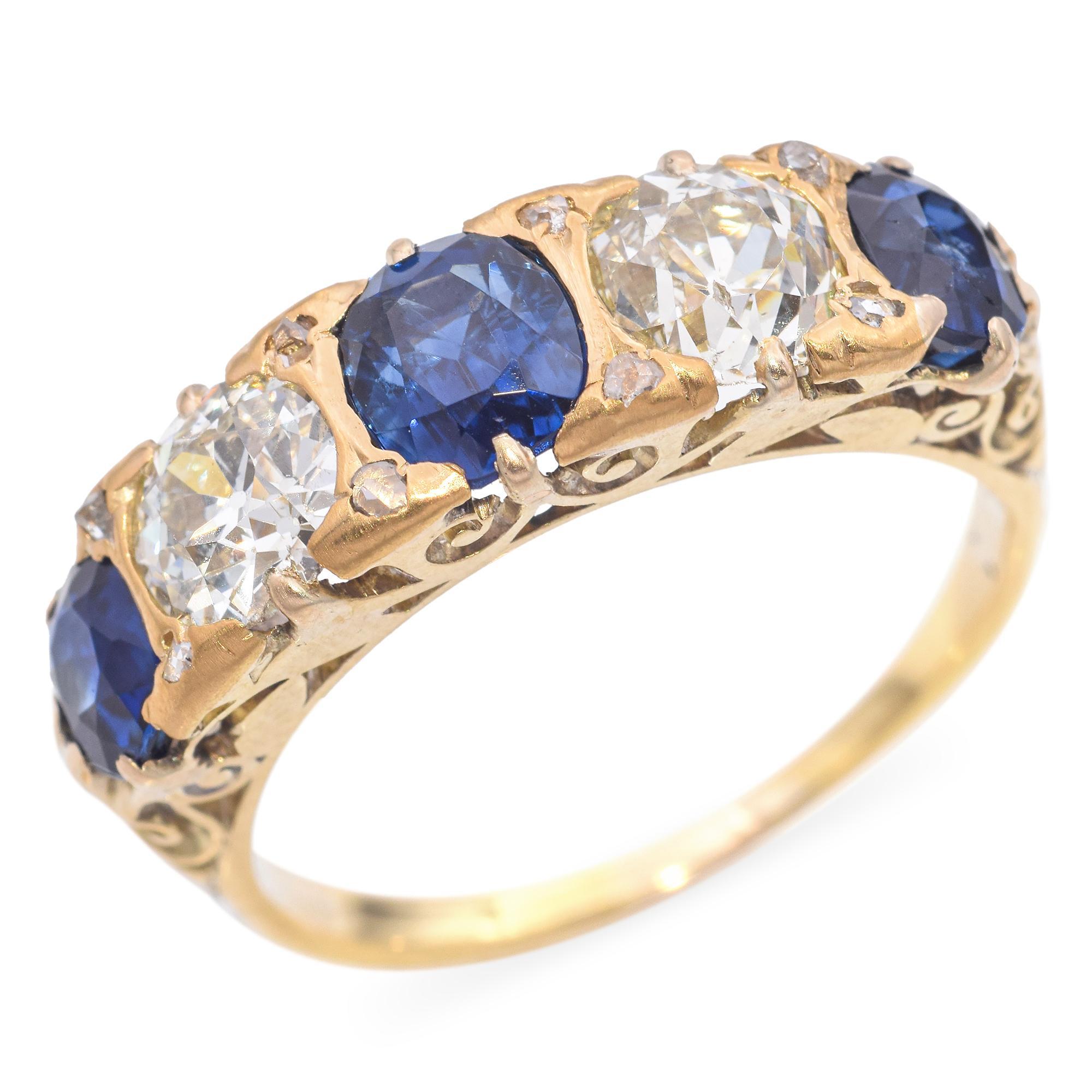 The design features alternating oval sapphires and old European cut diamonds, each set in a secure handmade prong setting. The sapphires exhibit a deep, rich blue hue, while the diamonds are brilliant and clear. The gold setting adds a warm