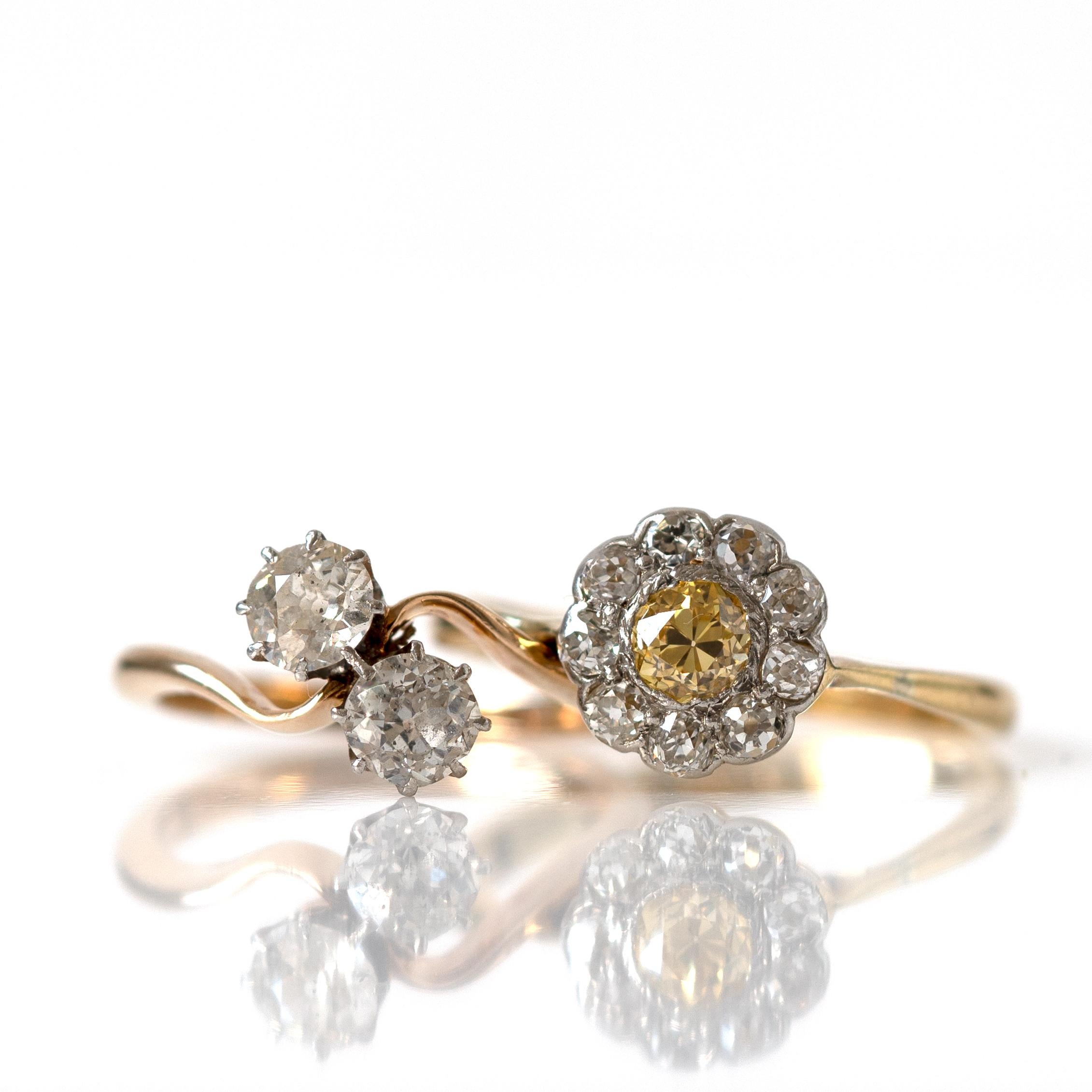 Edwardian era 18ct white and yellow gold 'toi et moi' ring featuring two antique old Eureopean cut diamonds intertwined together. In English 'toi et moi' translates to 'you and me', a deeply romantic symbolic ring. The diamonds are closely
