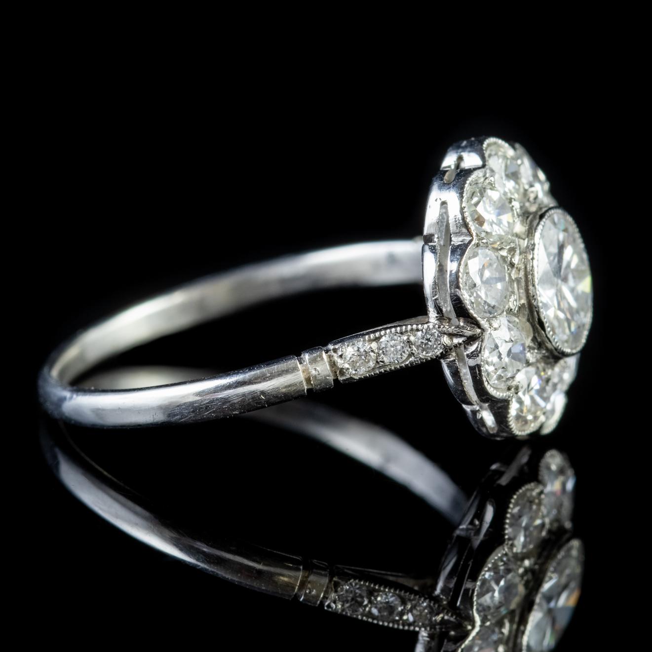 This unique Diamond cluster ring was created at the end of the Edwardian period and boasts ten old cut Diamonds mounted in an 18ct White Gold gallery. 

The central stone is 0.65ct surrounded by 0.1ct Diamonds, giving the ring a total of 1.80ct. The