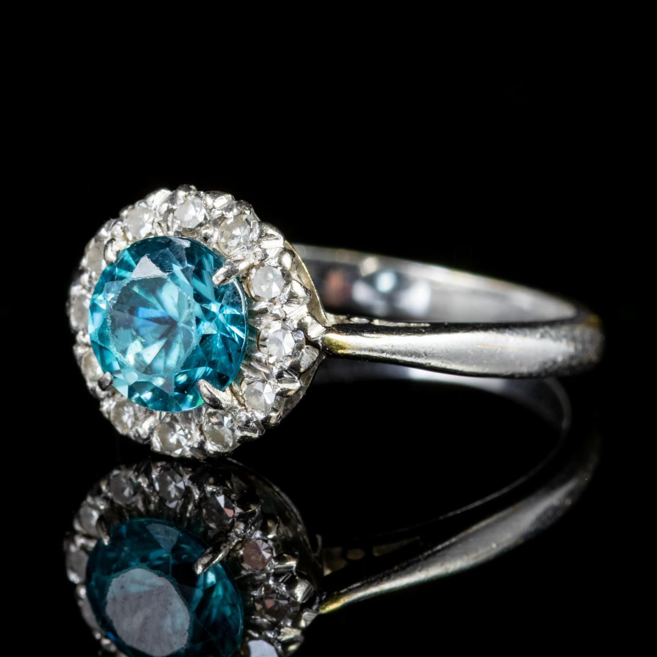 A fabulous antique Edwardian cluster ring adorned with a 0.80ct Blue Zircon in the centre haloed by sparkling Diamonds, approx. 0.45ct in total. 

Blue Zircon is a lovely shade of teal/ blue and was once said to bring prosperity and wisdom to its