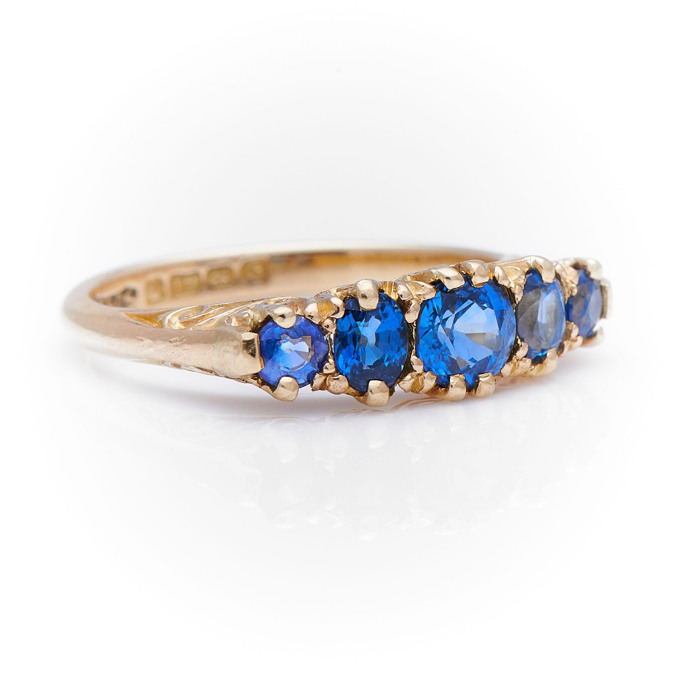 Sapphire and diamond ring, 1902, possibly Turnbull Brothers. This elegant five-stone ring is set with a series of graduated unheated Sri Lankan sapphires, very well-matched for colour and clarity. The sides retain the beautiful scrollwork that is a