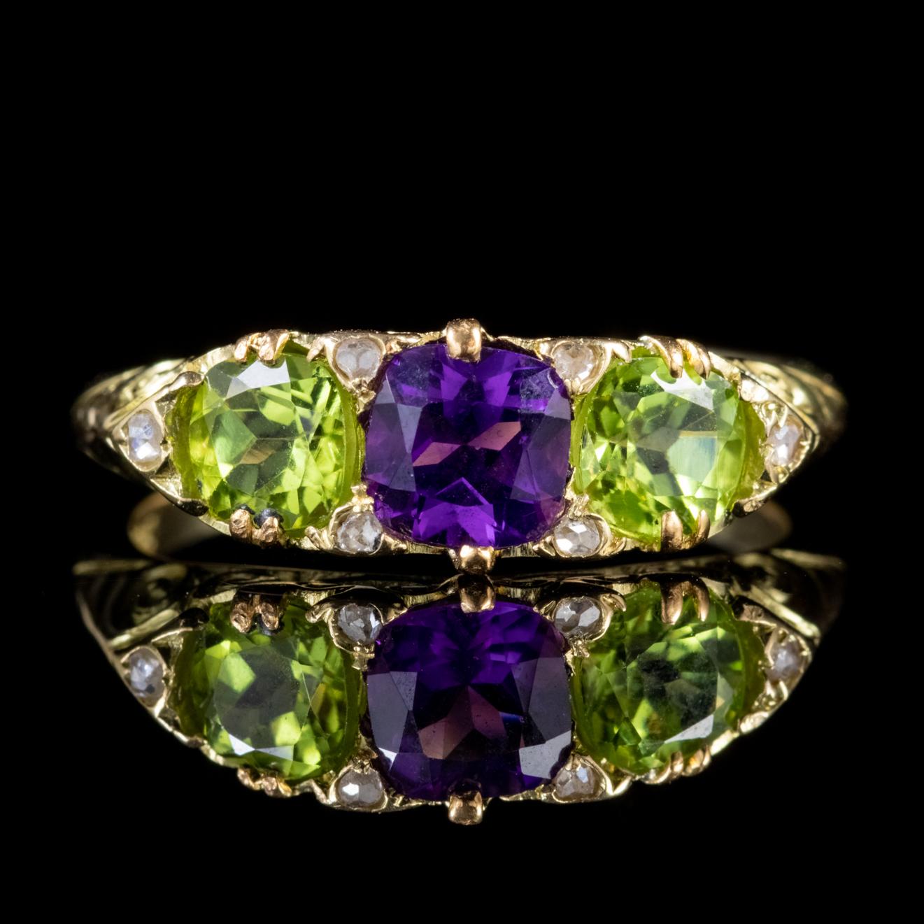 A colourful Antique Suffragette ring made during the Edwardian era Circa 1915. The face of the ring is set with a fabulous approx. 0.75ct Amethyst flanked by two 0.60ct Peridots with six twinkling Diamonds set in-between. 

Suffragette jewellery was