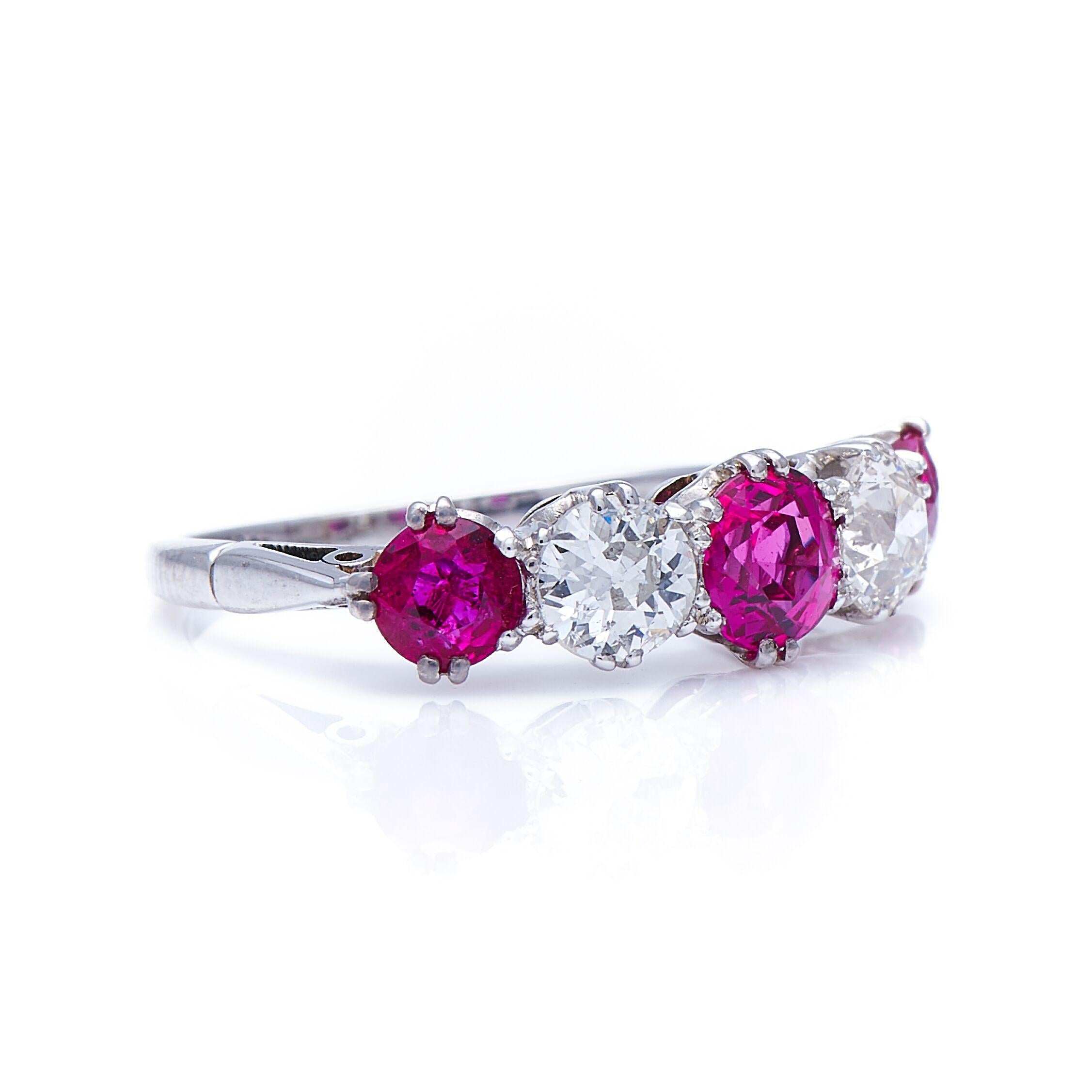 Diamond and ruby ring, early 20th century. This classic five-stone ring is set with a line of three lively deep pinkish rubies spaced with two circular-cut diamonds. Five stone rings are both traditional and versatile, substantial enough to work