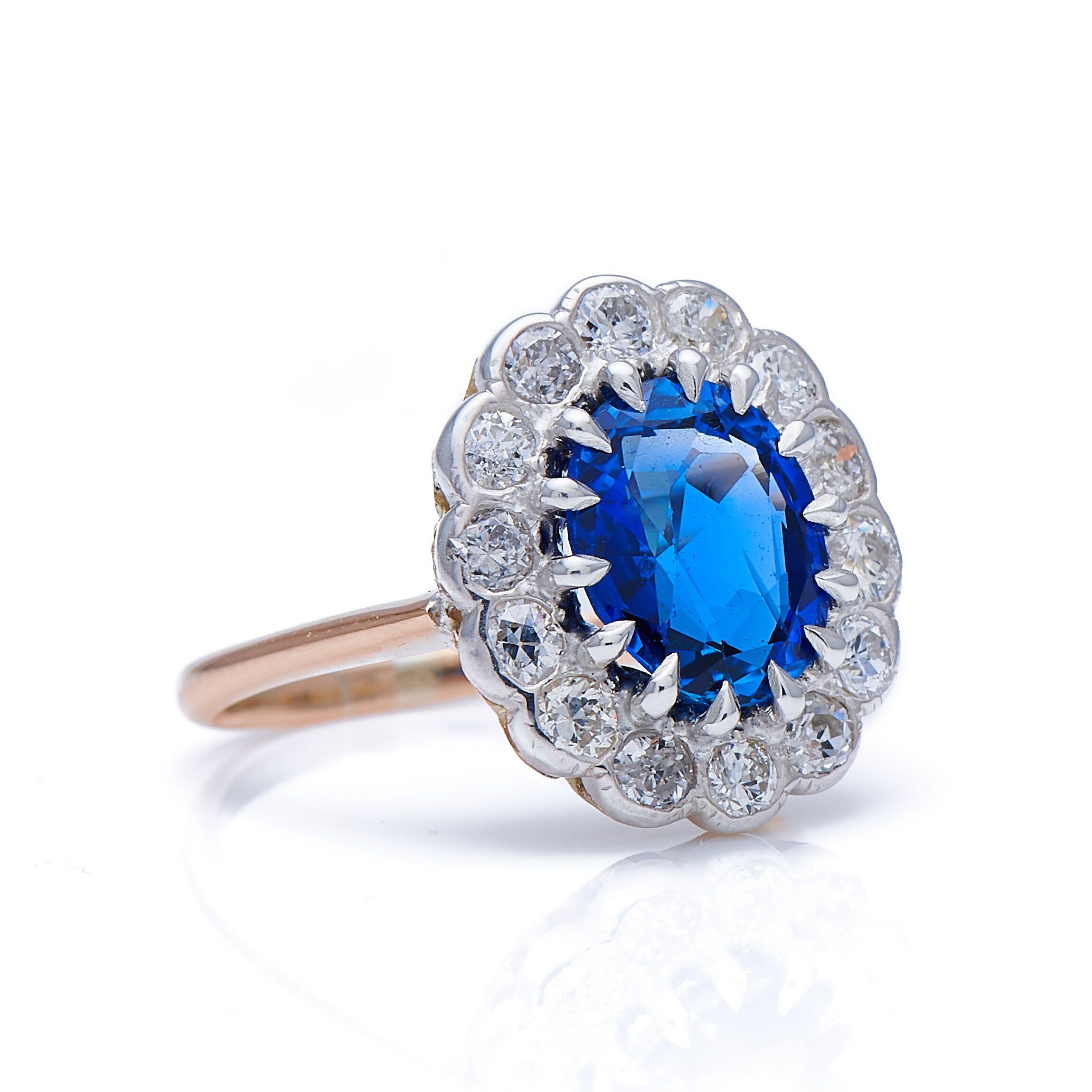 Sapphire and diamond ring. An outstanding example of a mid-size sapphire and diamond cluster, this would make an excellent choice for an engagement ring. At its centre is a beautiful unheated Burmese sapphire of a classic mid blue, with excellent