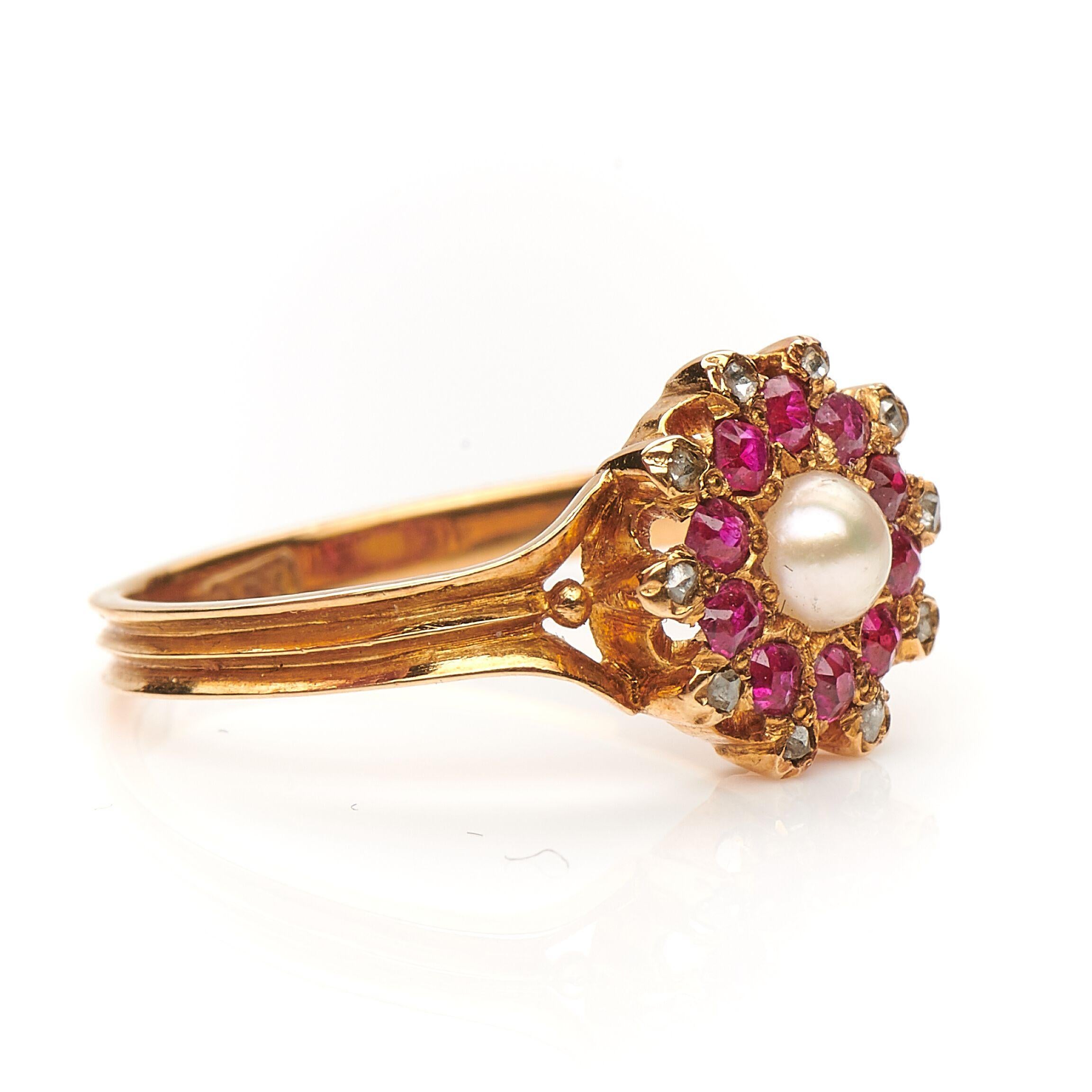 Edwardian, ruby, diamond and pearl dress ring, circa 1910. Set to centre a natural spilt pearl framed by rubies with an outer boarder of rose-cut diamonds. The wonderful colour combination is what makes this ring unique, the cluster is a burst of