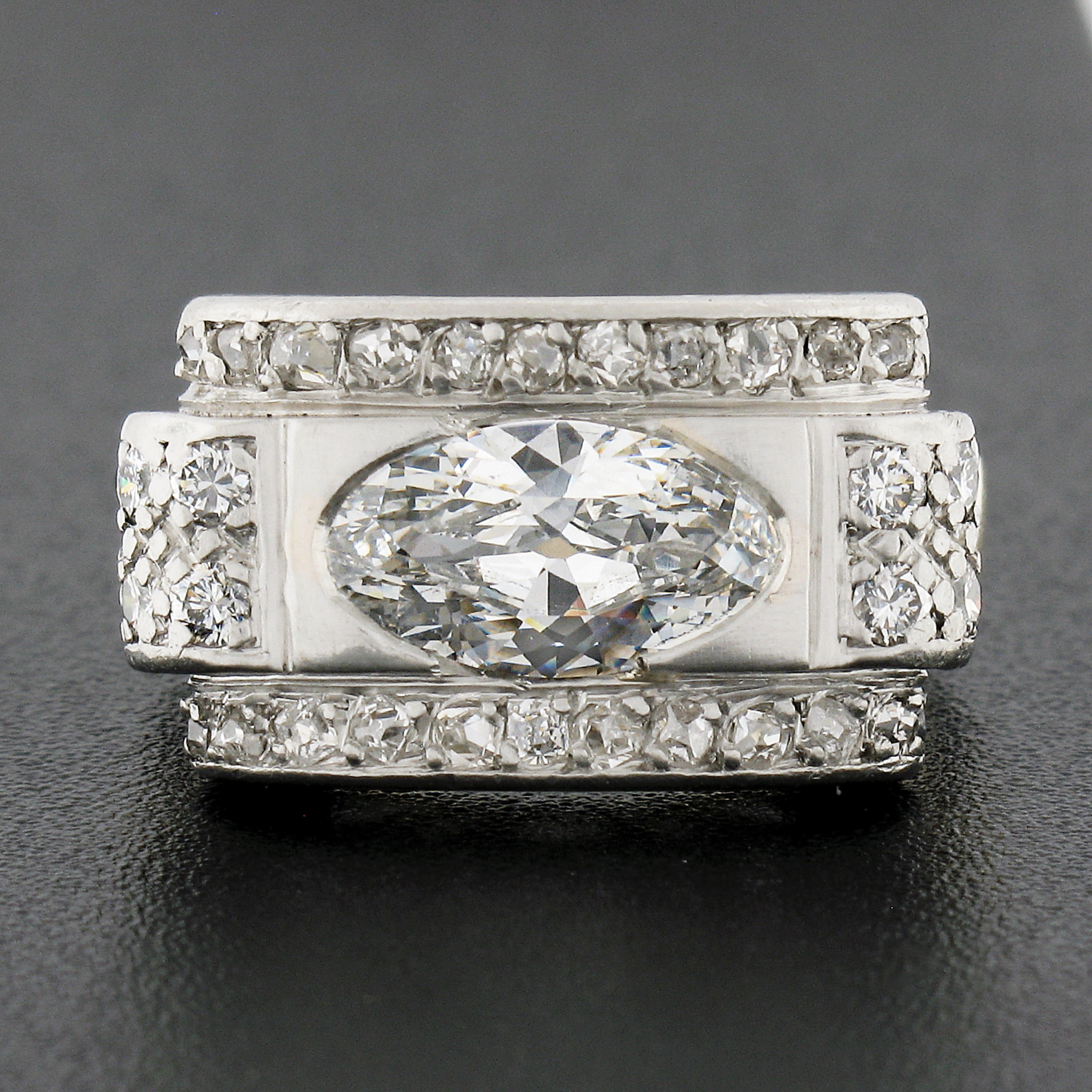 Here we have an absolutely breathtaking antique diamond ring that was crafted from solid 18k yellow gold and platinum. This uniquely designed platter style ring features a gorgeous, GIA certified, elongated oval brilliant cut diamond that is neatly