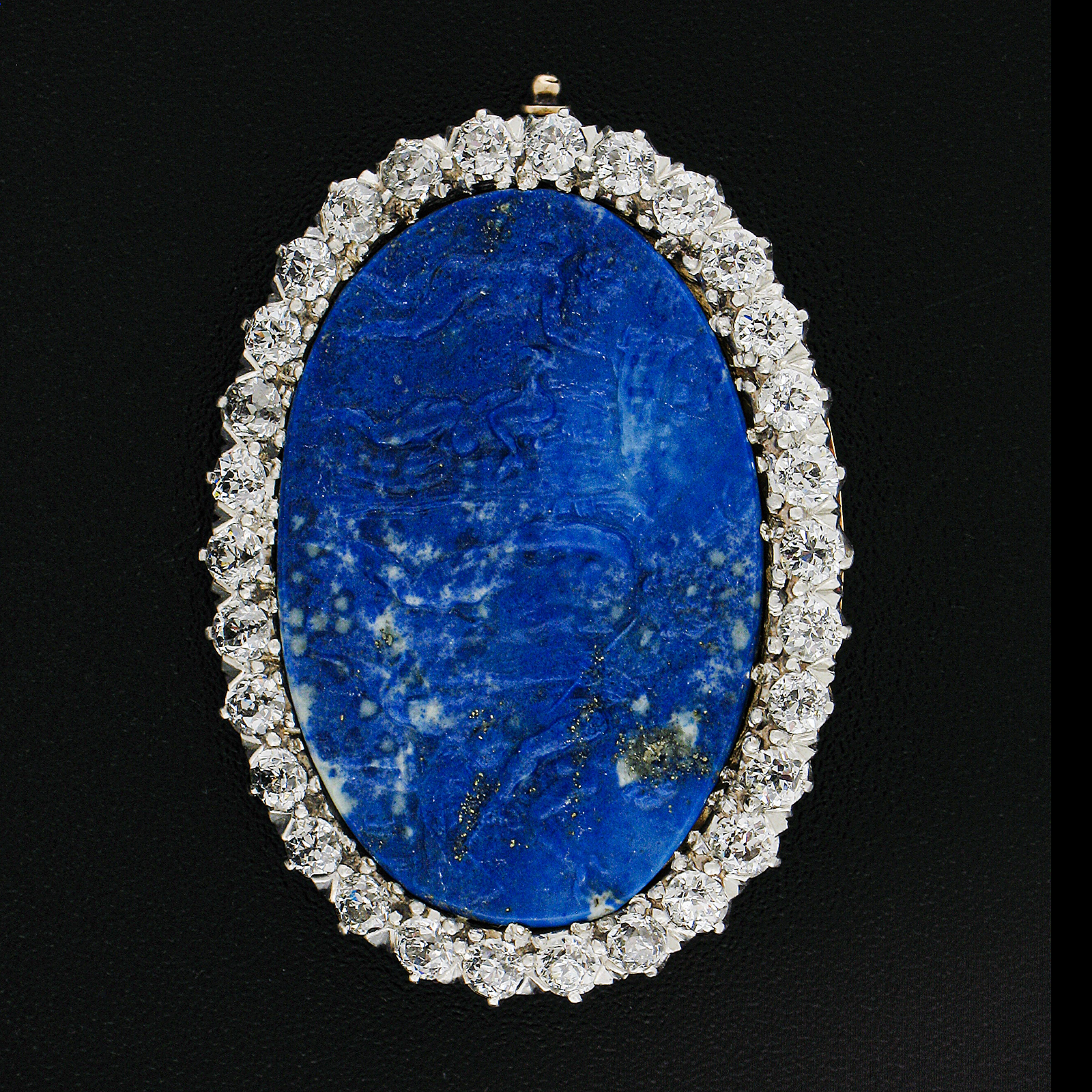 --Stone(s):--
(1) Natural Genuine Lapis Lazuli - Scantily Clad Gathering Carving - Oval Shape - Prong Set - Blue Color - 31.3x21.5mm (approx.)
(30) Natural Genuine Diamonds - Old European & Old Mine Cut - G-I Color - VS1/VS2 Clarity - 2.40ctw