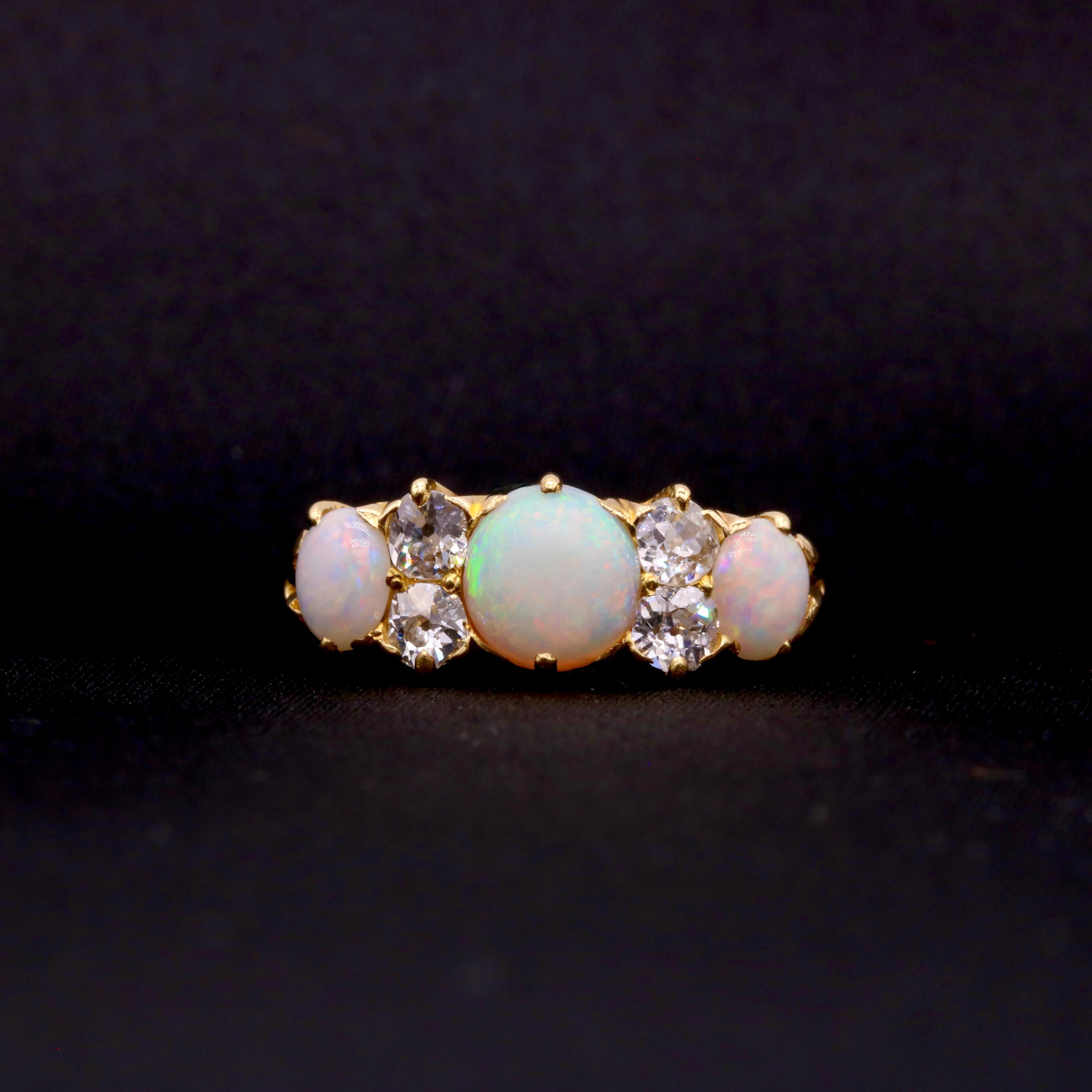 Anello antico con opale, diamanti e oro giallo, composto da un opale cabochon rotondo, due opali cabochon ovali e quattro diamanti taglio vecchio, in oro giallo 18 carati. 

La cosa che preferisco di questo anello antico in oro giallo 18 carati con