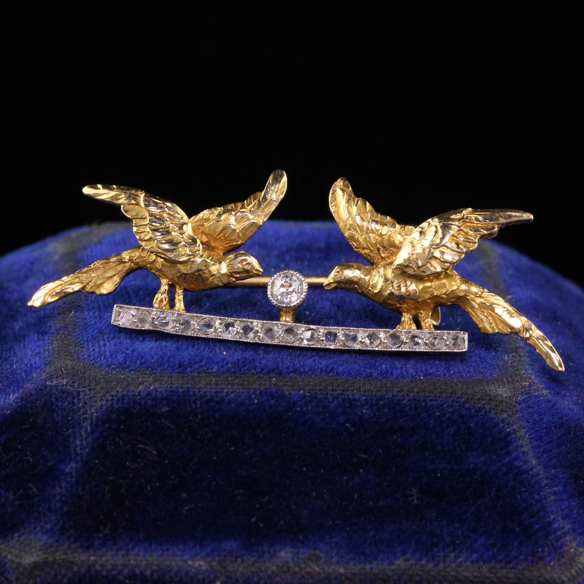 Beautiful Antique Edwardian 18K Yellow Gold Platinum Top Rose Cut Double Bird Pin. This beautiful pin is crafted in 18k yellow gold and platinum top. The pin features rose cut and an old european cut diamond in the center. It shows a beautiful scene
