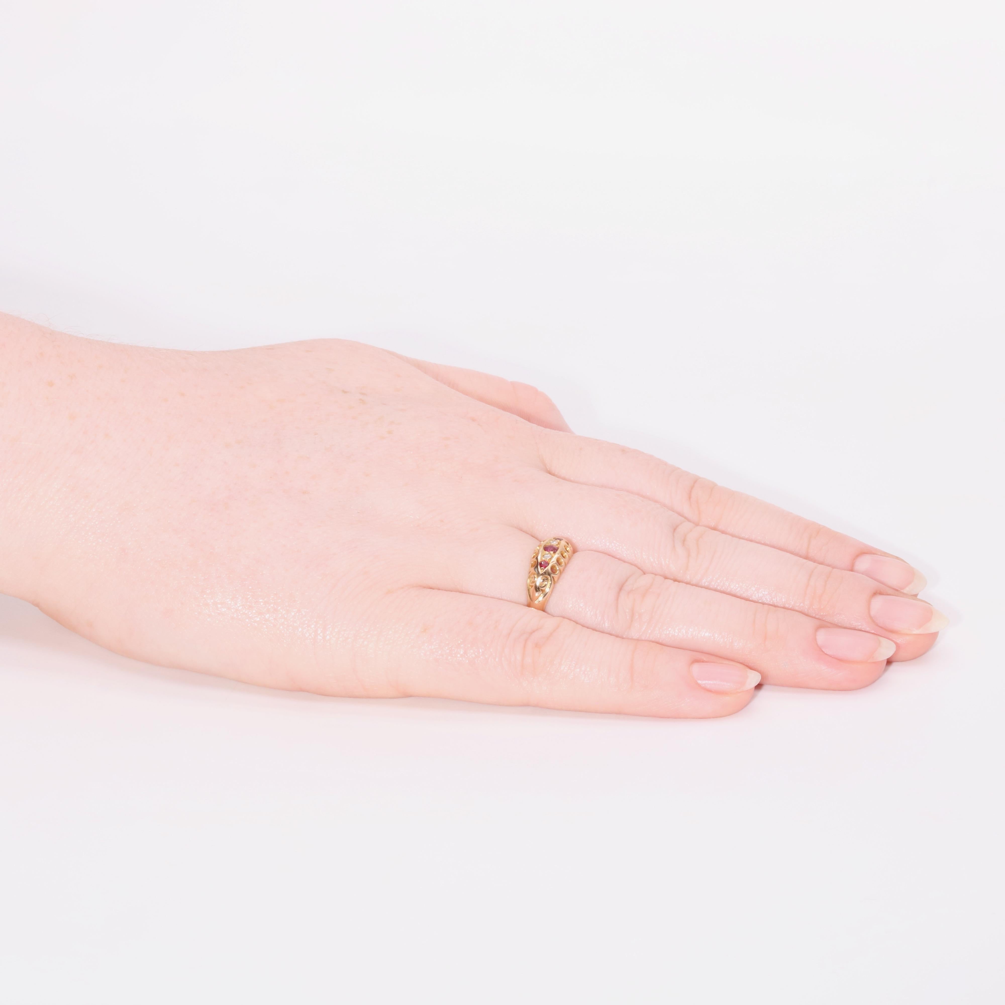An antique ruby and diamond ring in yellow gold, comprising of 3 round cut rubies and 2 old cut diamonds, set in 18 karat yellow gold, to an 18 karat yellow gold band. 

The sparkling old cut diamonds are bright and well matched, nestled between the