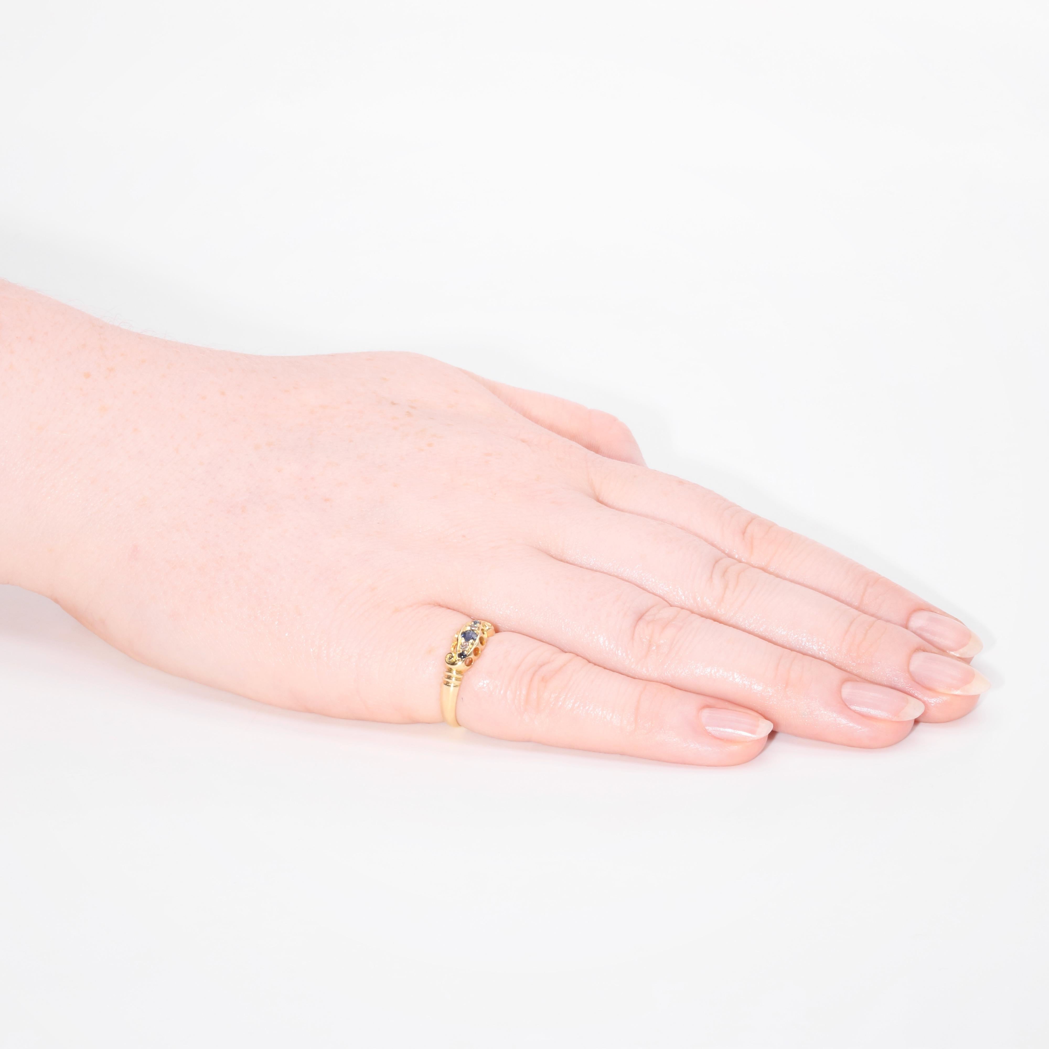 An Edwardian sapphire, diamond, and yellow gold ring, comprising three round cut blue sapphires, and two old single cut diamonds, set in 18 karat yellow gold, to an 18 karat yellow gold band.

This elegant ring is set to the centre with a rich,