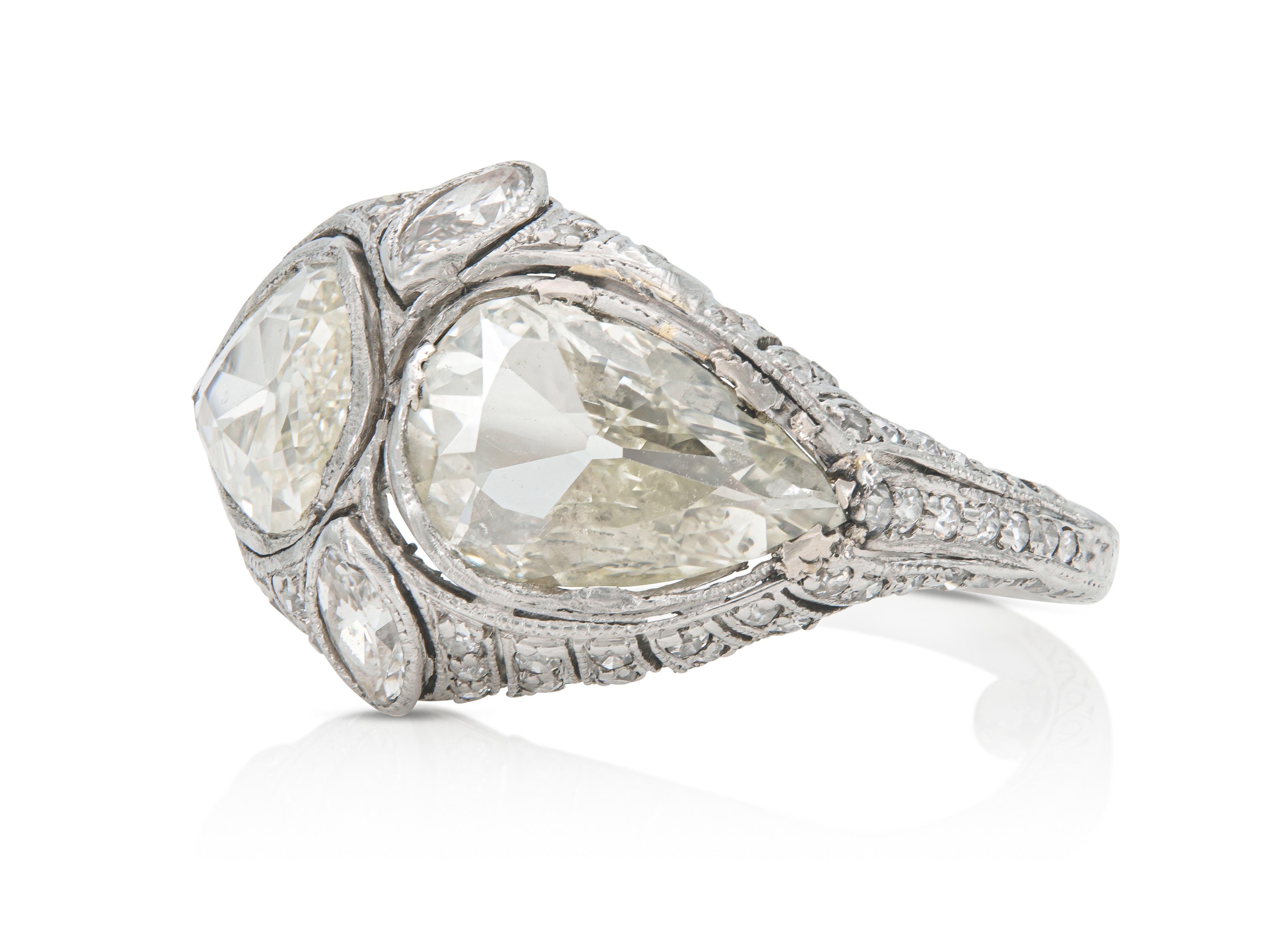 Finely crafted in platinum with two Pear-Shaped Diamonds weighing a total of 2.65 carats, as well as Marquise and Single cut Diamonds weighing approximately a total of 0.90 carat.
Circa early 1900s
Size 5, resizable