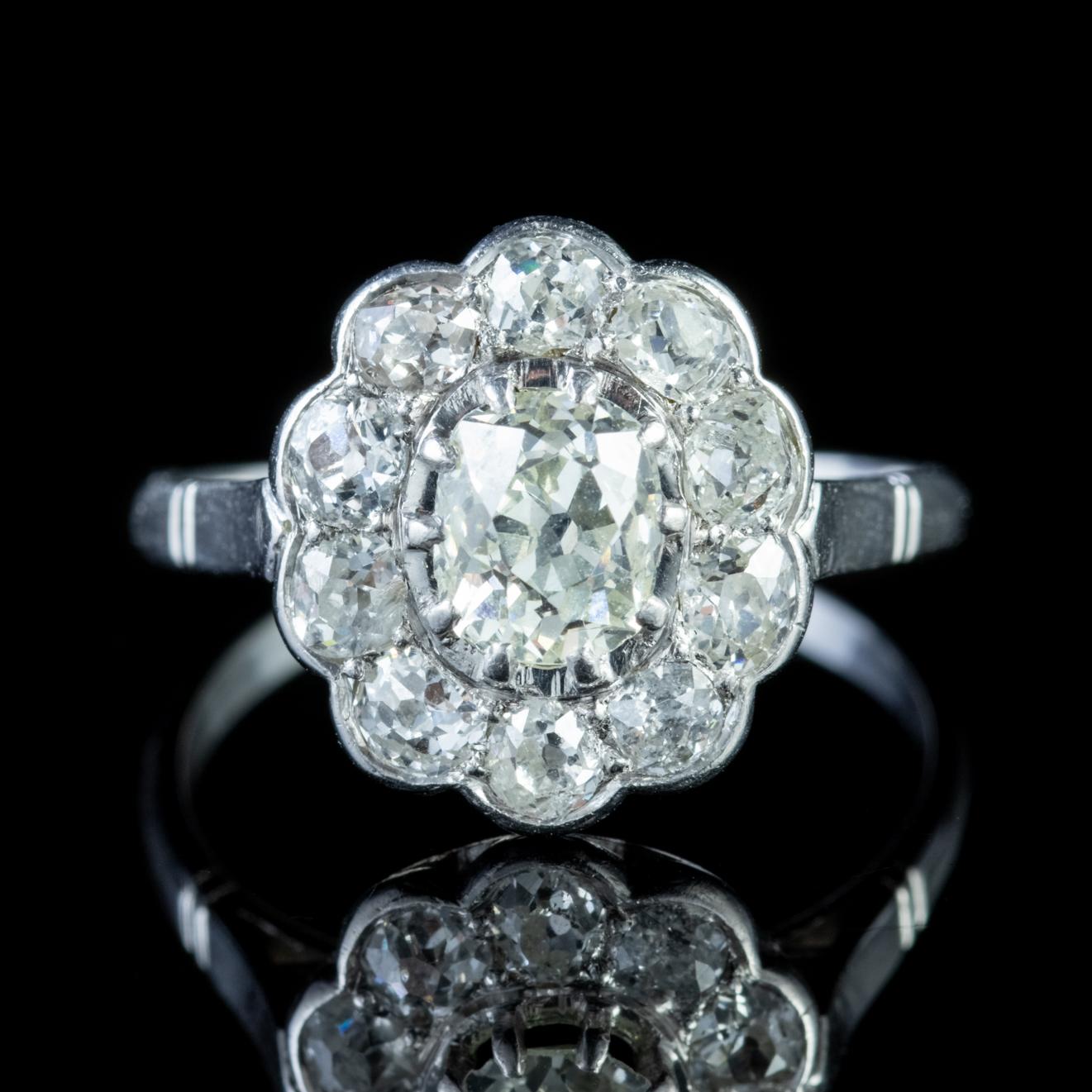 A magnificent antique Edwardian cluster ring adorned with a stunning 0.90ct old cushion cut Diamond in the centre complemented by a 1ct halo of smaller cushion cut Diamonds which are all beautiful clarity stones with lots of sparkle. 

Old Cut