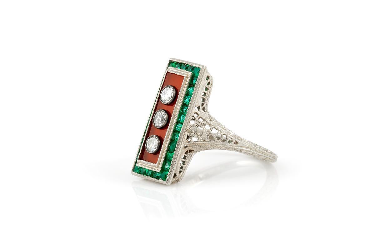 Finely crafted in 18k white gold featuring Carnelian and French cut Emeralds, as well as Old European cut Diamonds weighing a total of approximately 0.20 carat.
Circa late 1910s
Size 4, resizable