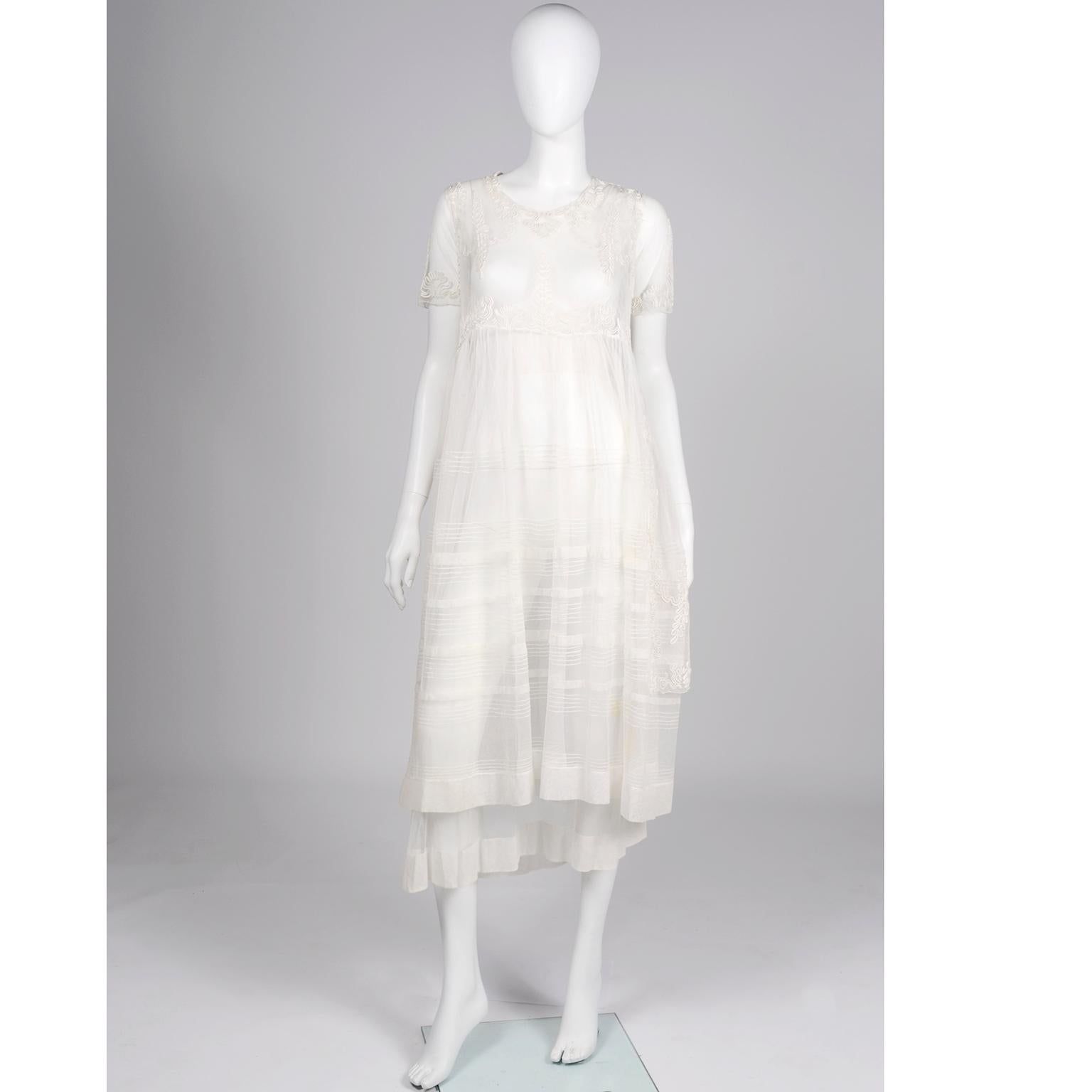 This is an incredible vintage dress from the 1910's!! The soutache detail is so well done and we especially love the pretty three layers of soft netting . The base layer is solid with a with a thick tulle hemline and waistband. The top layer is a
