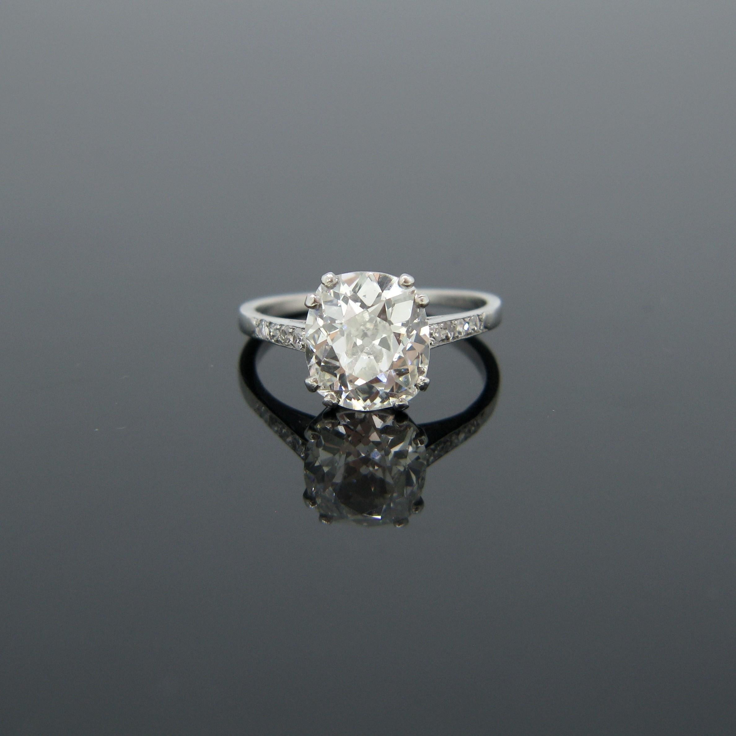 This stunning ring is from the Edwardian era and is fully made in platinum (tested). The diamond is a beautiful old cut cushion diamond shouldered with four single cut diamonds on each side. The diamond weighs 2.97ct, colour I and clarity SI2 – it
