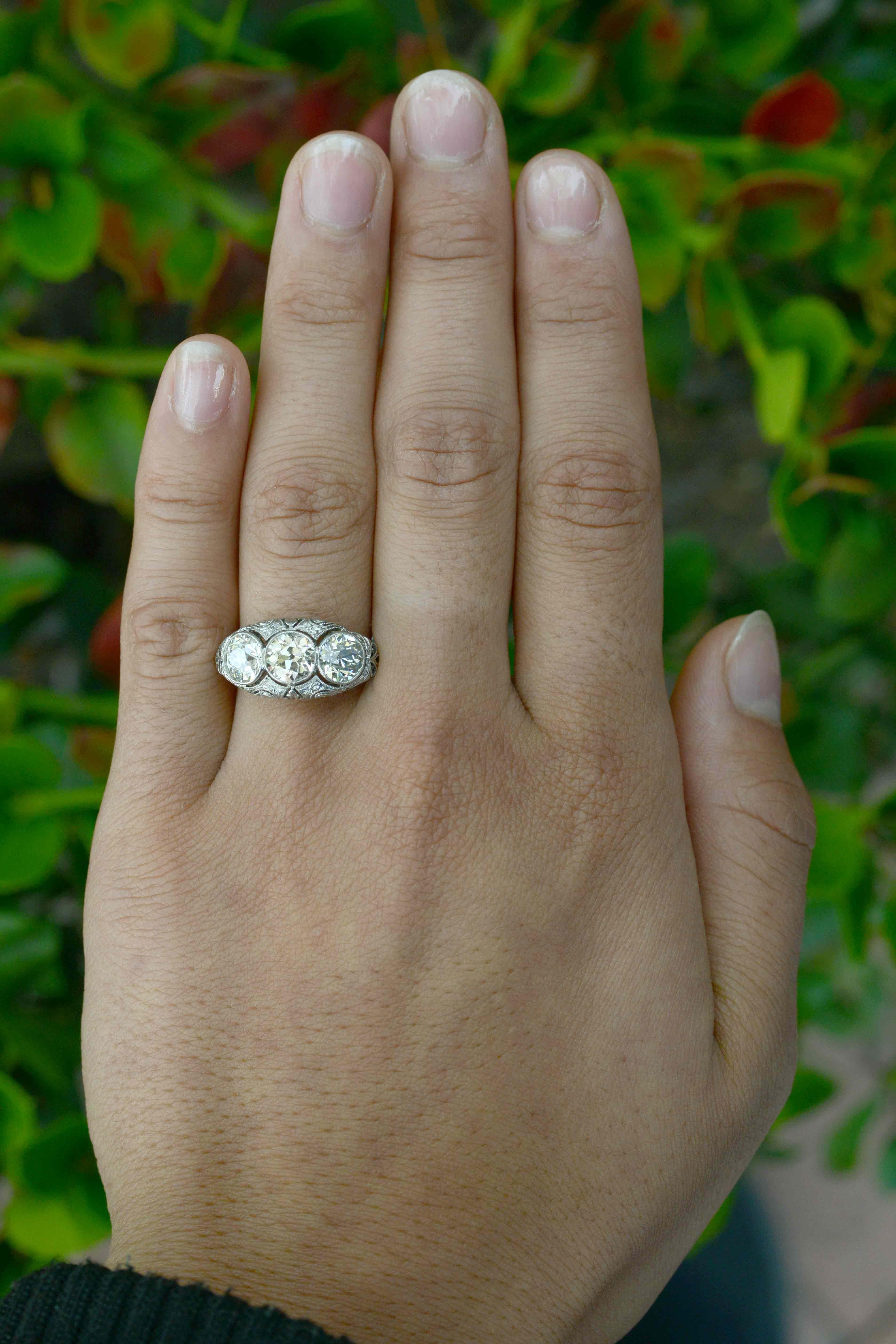 A most enchanting Edwardian Style 3 stone diamond engagement ring. Boasting 3 carats of old mine cuts, these 