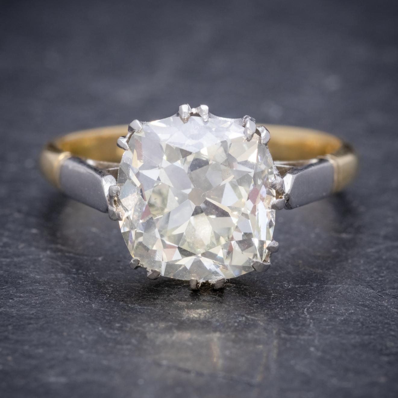 A magnificent antique Edwardian solitaire ring adorned with a stunning old cushion cut Diamond which has been weighed at 3.88ct and sparkles beautifully in the light. 

The stone is claw set in a lovely Platinum mount with 18ct Yellow Gold