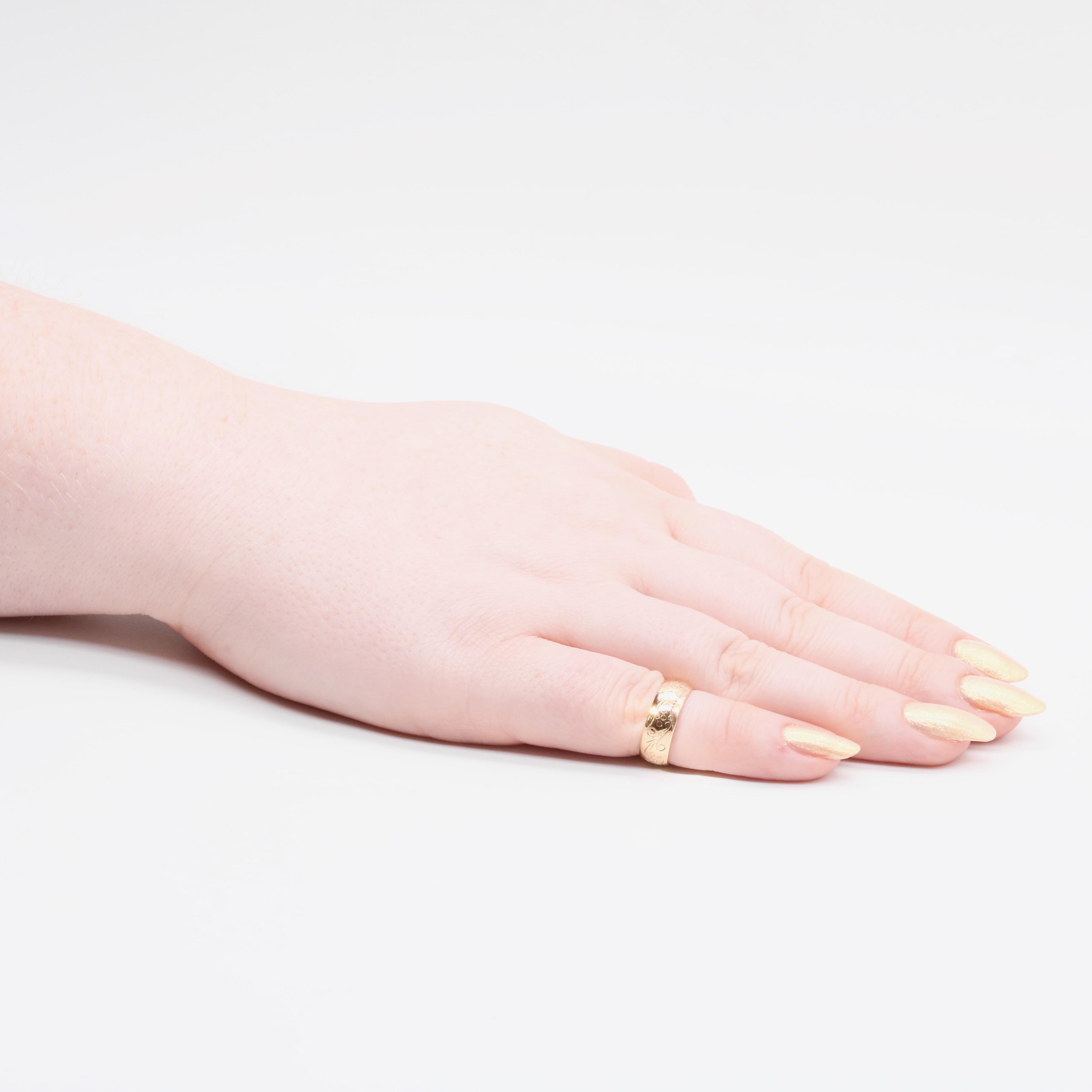 An antique, yellow gold ring, to form an engraved 22 karat yellow gold band. 

This beautiful ring is wonderfully tactile, with a lovely weight to it, and lovely smooth, domed shape. The chunky band is engraved with a floral and foliate motif, which