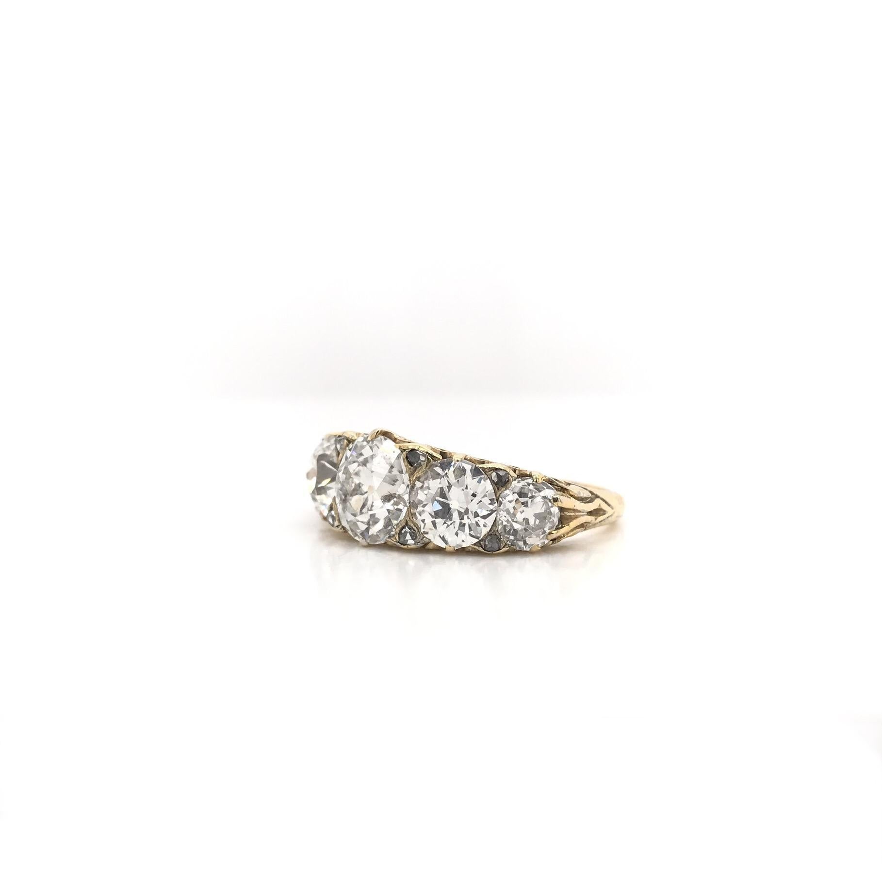 This exceptional antique piece was crafted sometime during the Edwardian design period (1900-1920). The 18K gold setting proudly displays five stunning Old European cut antique diamonds. The center diamond measures approximately 2 carats, grades