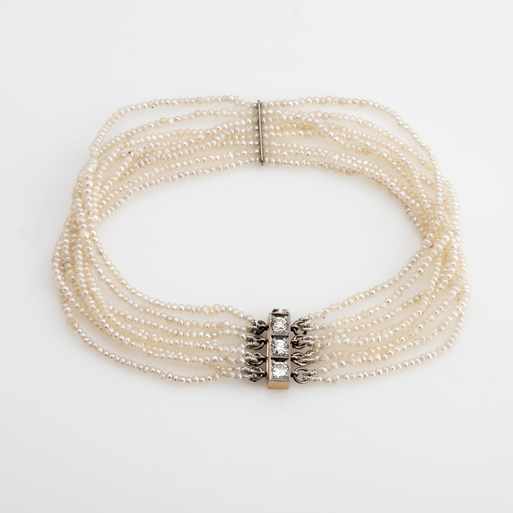 
Finely detailed antique Edwardian bracelet (circa 1910s), finished with a 14 karat yellow gold and platinum diamond set clasp. 

8 strands of natural seed pearls measuring 1.5mm (average). The clasp is set with three estimated 0.10 carat (each) old