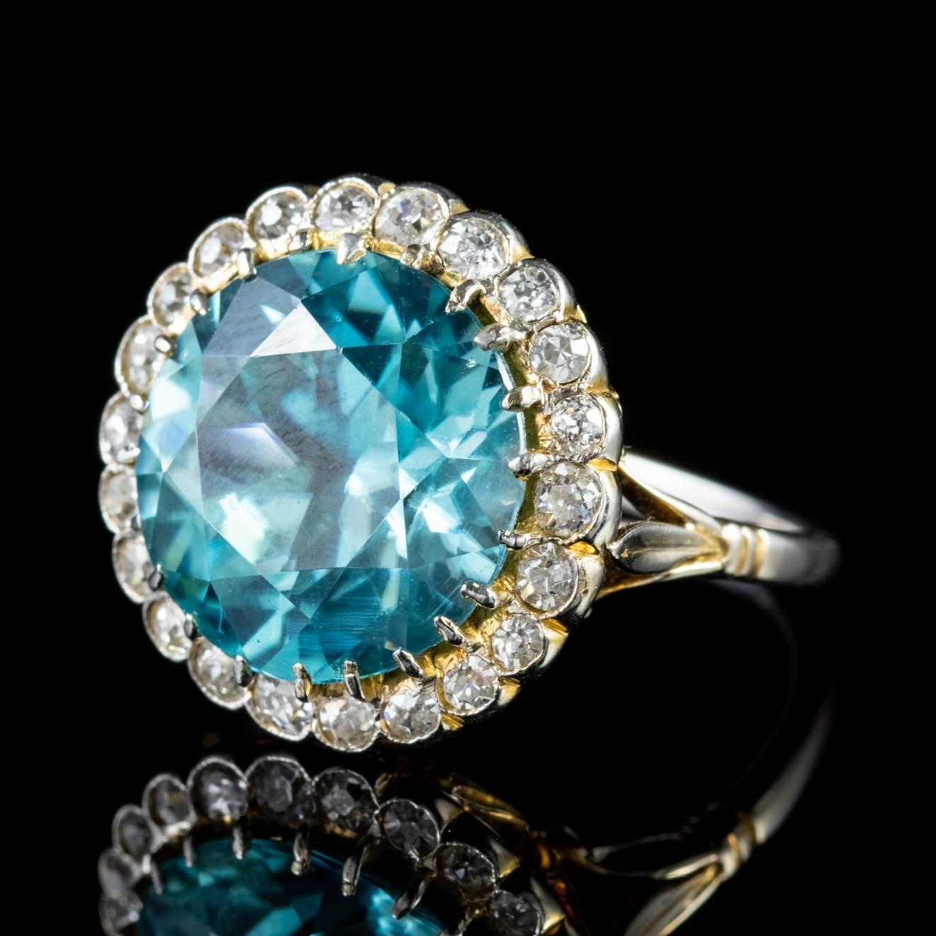 A spectacular antique Edwardian cluster ring adorned with a magnificent 8ct Blue Zircon which is a lovely shade of teal/ blue and haloed by sparkling Diamonds which total to approx. 1.10ct.

The stones are claw set in a lovely 18ct Yellow Gold