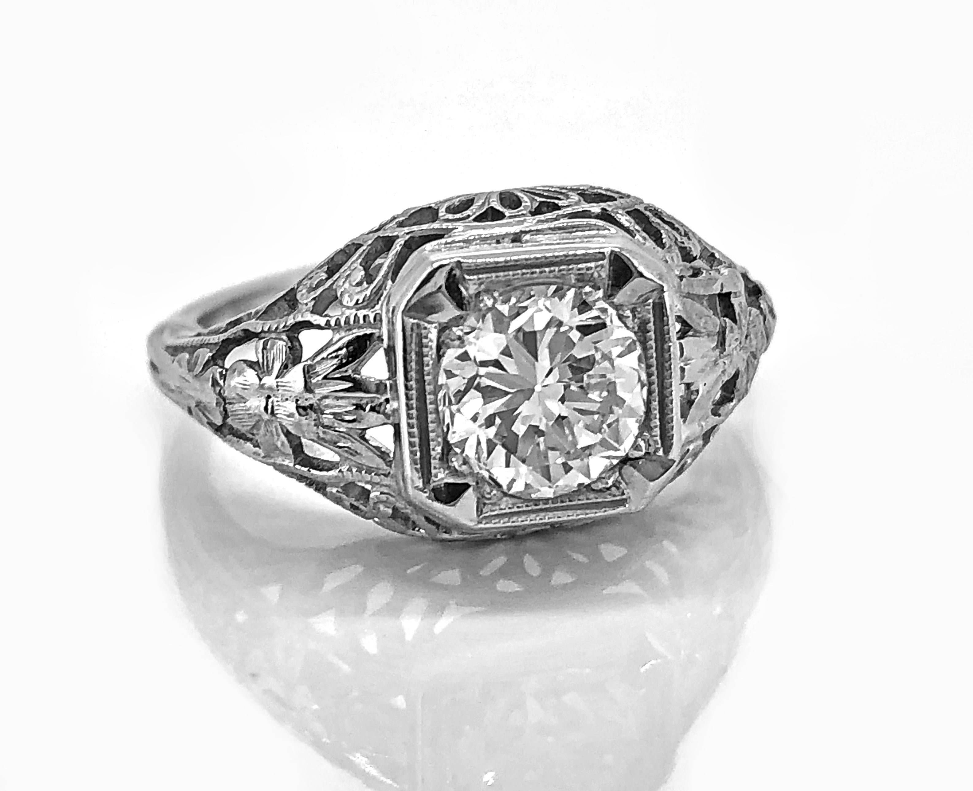 An antique engagement ring crafted in 18K white gold and features a .90ct. apx. center diamond with J color and exceptional VVS1 clarity. It does not get much better than this. The mounting was die struck giving the filigree its crisp design.