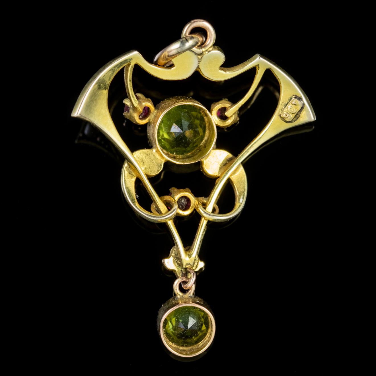 A fabulous antique Edwardian pendant decorated with a bright green central Peridot bordered with three smaller Rubies and eleven Pearls with a Peridot dropper hanging below. 

The Peridot is a stone of lightness and beauty and was believed to be a