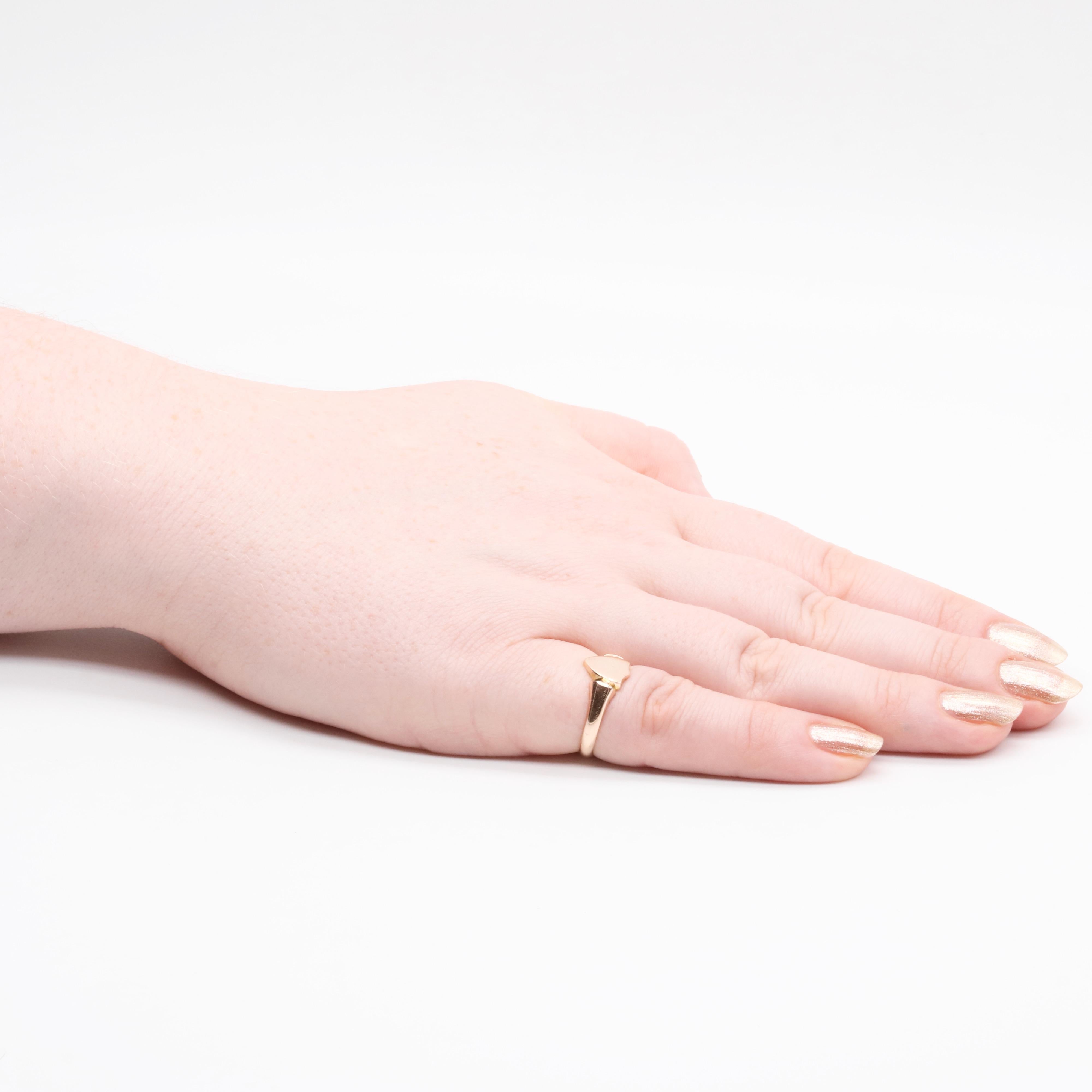 A rose gold signet ring, with a shield-shaped face, in 9 karat rose gold.

This lovely ring is in beautiful rose toned gold, which exudes a soft warmth. The face of the signet ring is shield-shaped, with rounded points. The face of the signet ring