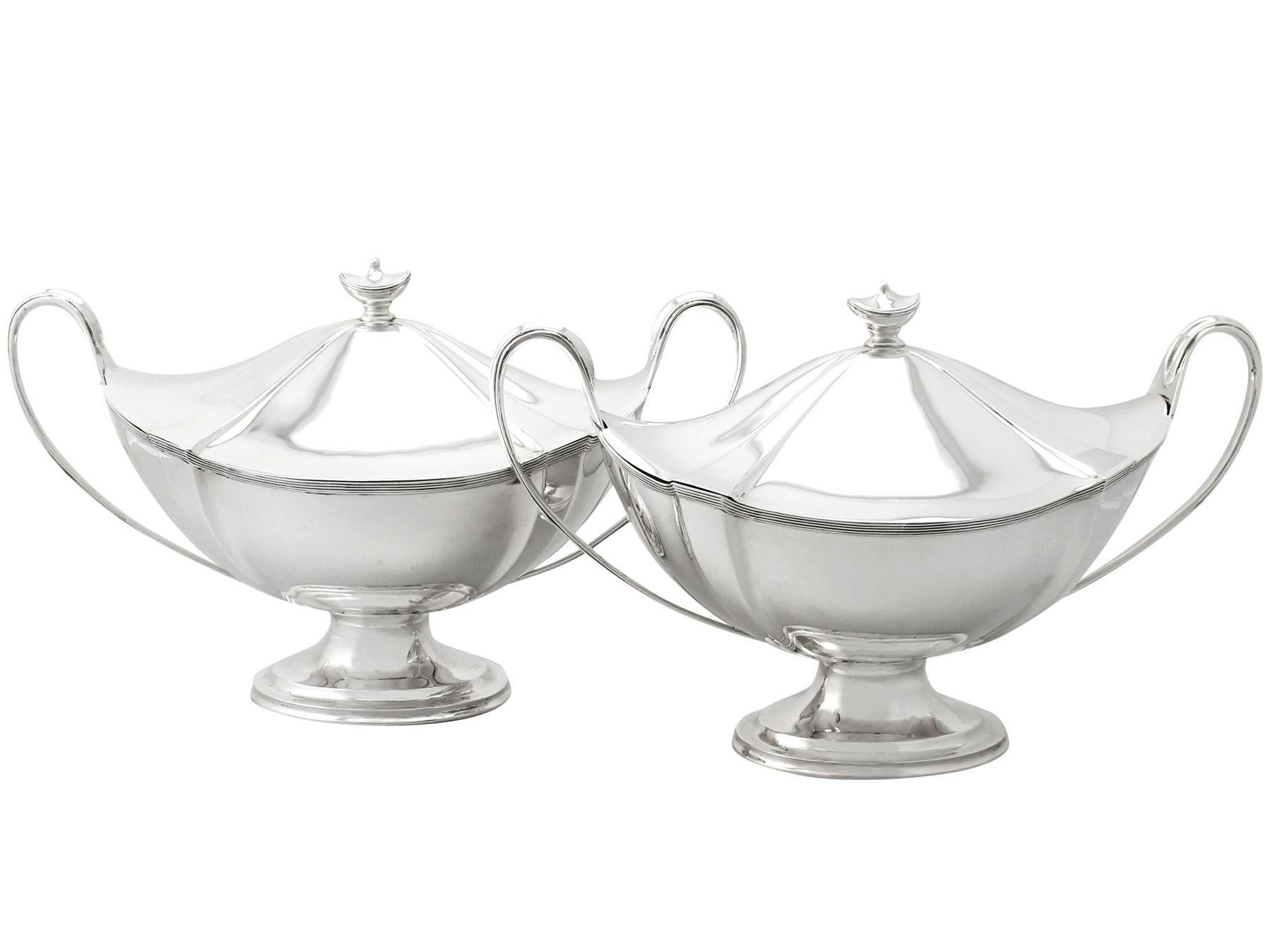 An exceptional, fine and impressive pair of antique Edwardian English sterling silver soup tureens in the Adams style; part of our dining silverware collection

These exceptional Edwardian sterling silver soup tureens have an oval Adams style form