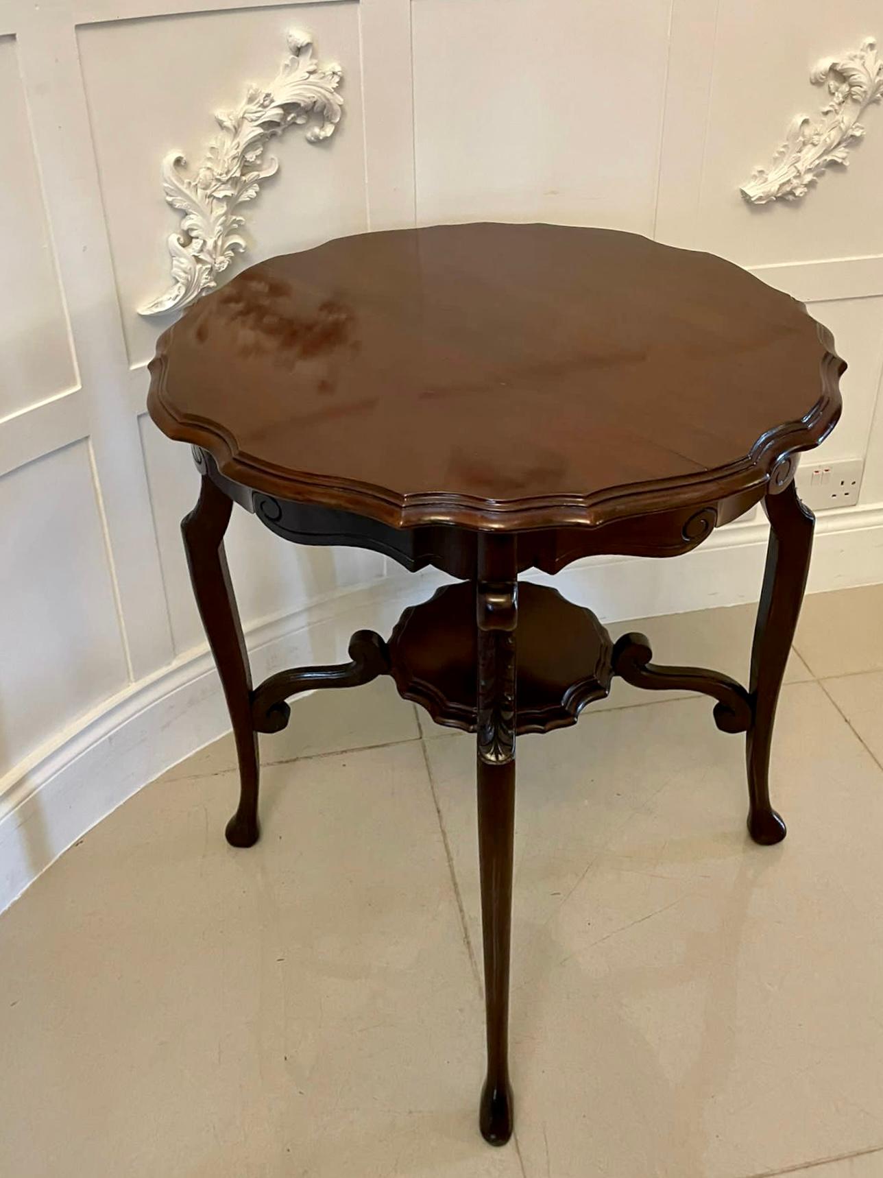 Antique Edwardian mahogany centre / lamp table with an attractive shaped top supported by four shaped carved cabriole legs with pad feet united by four shaped stretchers and a shaped under- tier.

A delightful example in lovely original
