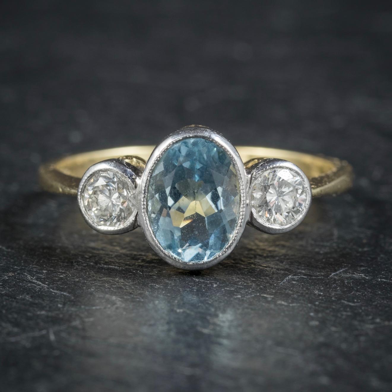 This classy antique Aquamarine and Diamond trilogy ring is Edwardian, Circa 1910.

The lovely ocean blue Aquamarine is 1.50ct with a 0.20ct old cut Diamond at either side. 

All set in an 18ct White Gold gallery with a Yellow Gold shank which is