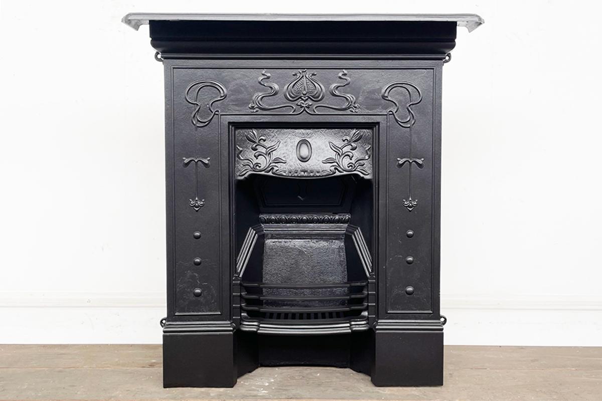 A pretty Edwardian Art Nouveau cast iron combination fireplace. Circa 1905.

This fireplace has been fully restored and finished in heat resisting black paint.

For detailed sizes please see the size diagram in the image gallery.
 